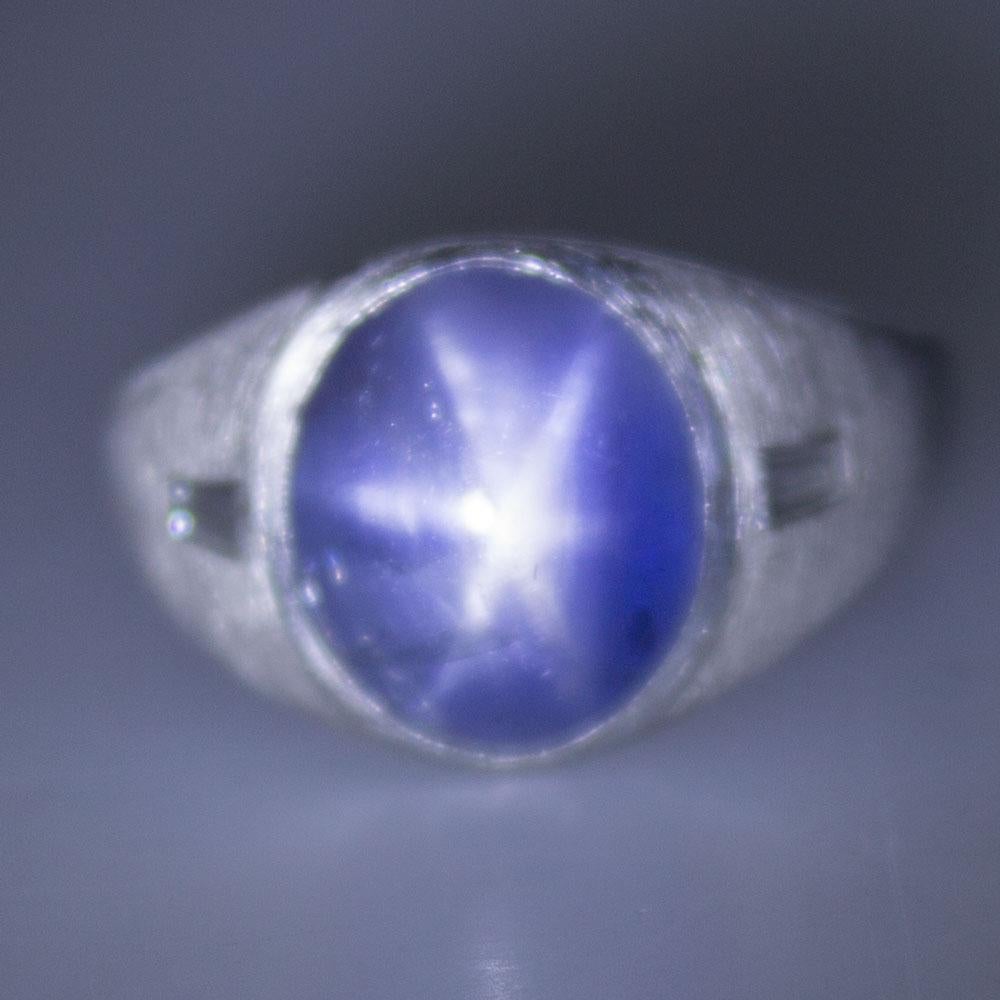 This fabulous 11.87 carat star sapphire diamond ring is fashioned platinum. The oval cabochon star sapphire has been certified by the GIA. The sapphire has No Heat enhancement and origin is Sri Lanka/Ceylon.  Two tapered baguette cut diamonds are
