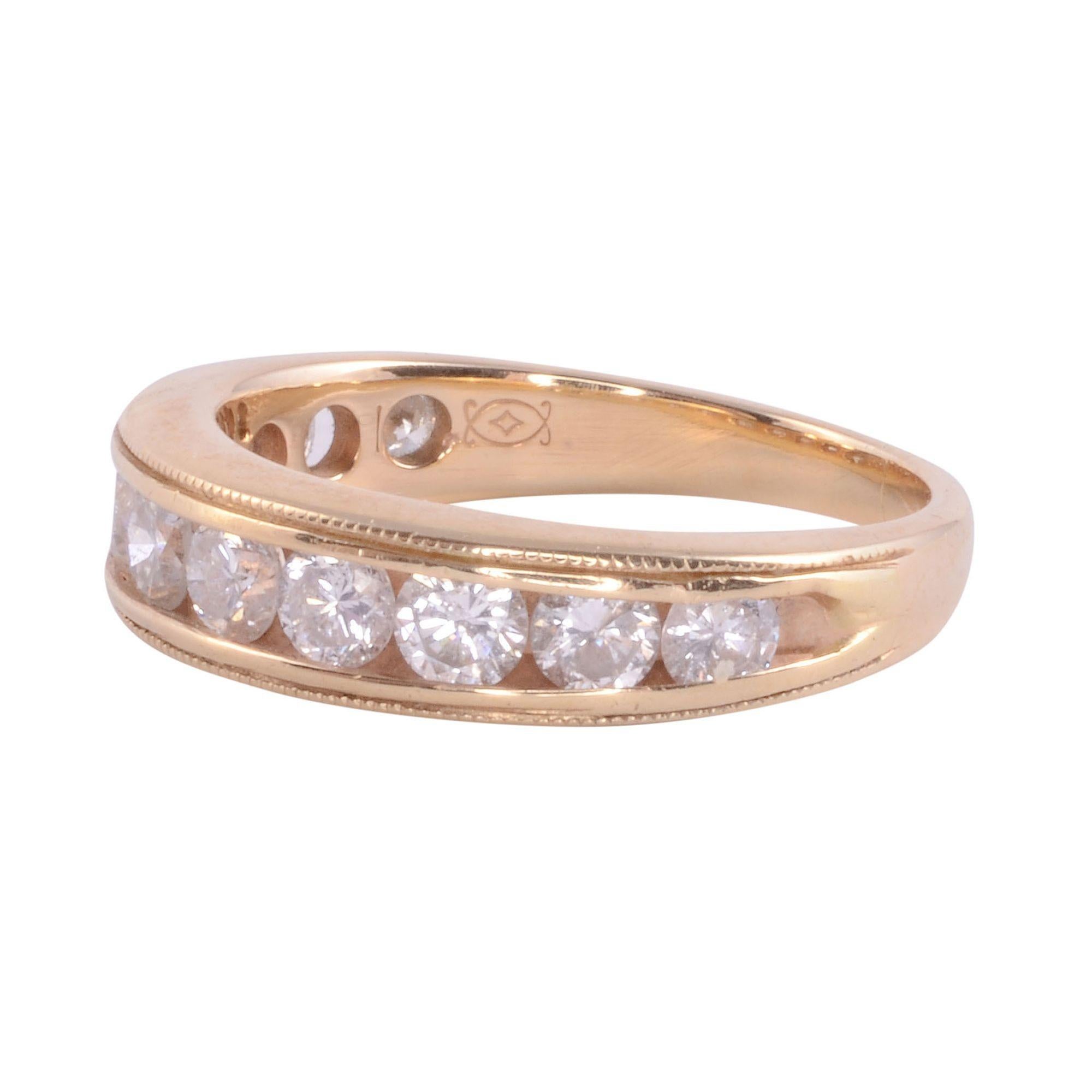 Estate 11 diamond 14KY band. This 14 karat yellow gold ring features 11 diamonds at .92 carat total weight. The diamonds have SI1 clarity and E-F color. This beautiful diamond band has milgrain detailing and is a size 5.25. [KIMH 127]
