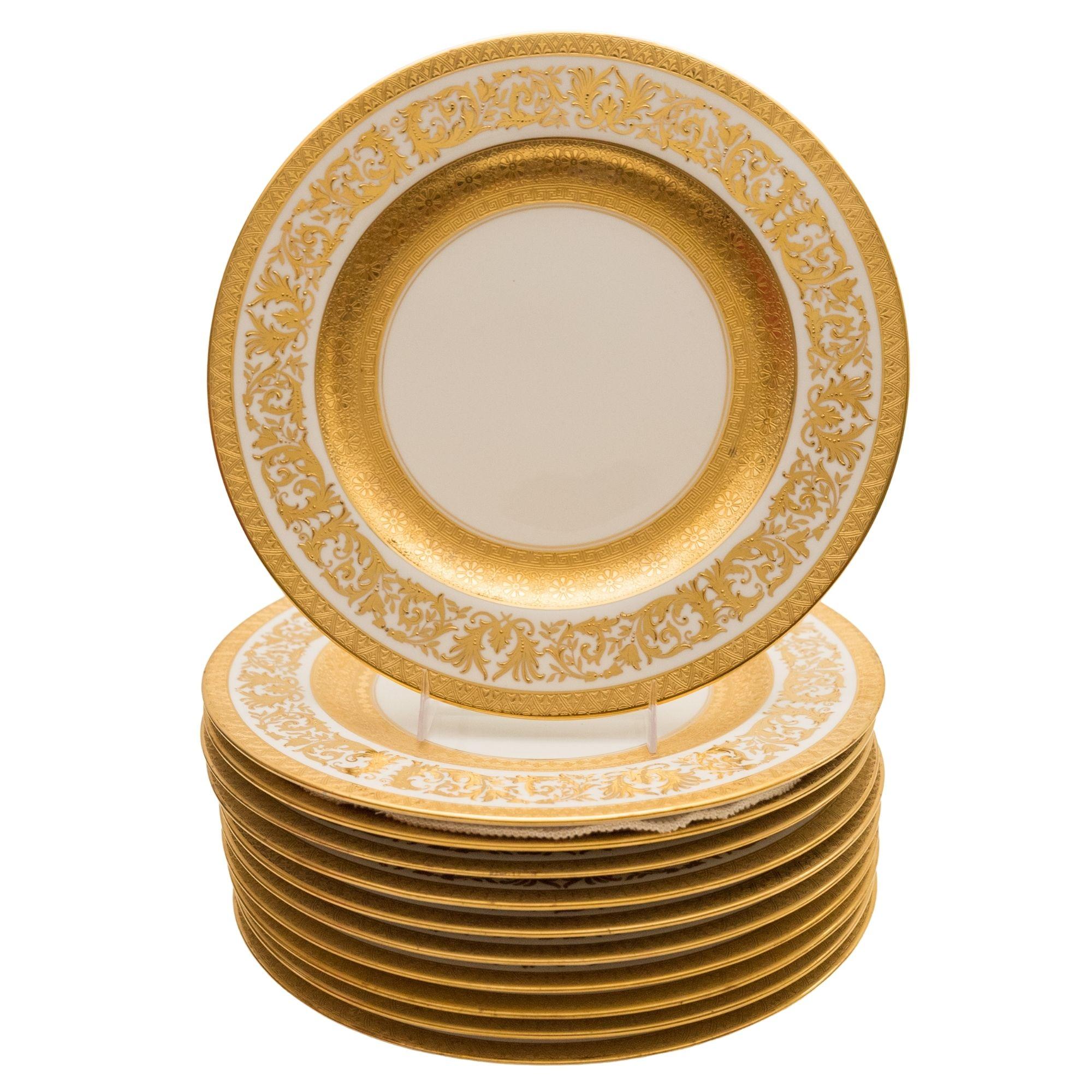 From one of the Gilded Age's finest porcelain manufacturers, Crown Staffordshire is this set of eleven dinner plates. They feature beautiful raised gilt work in their collars and an extra wide gold inner band. Custom ordered through the fine