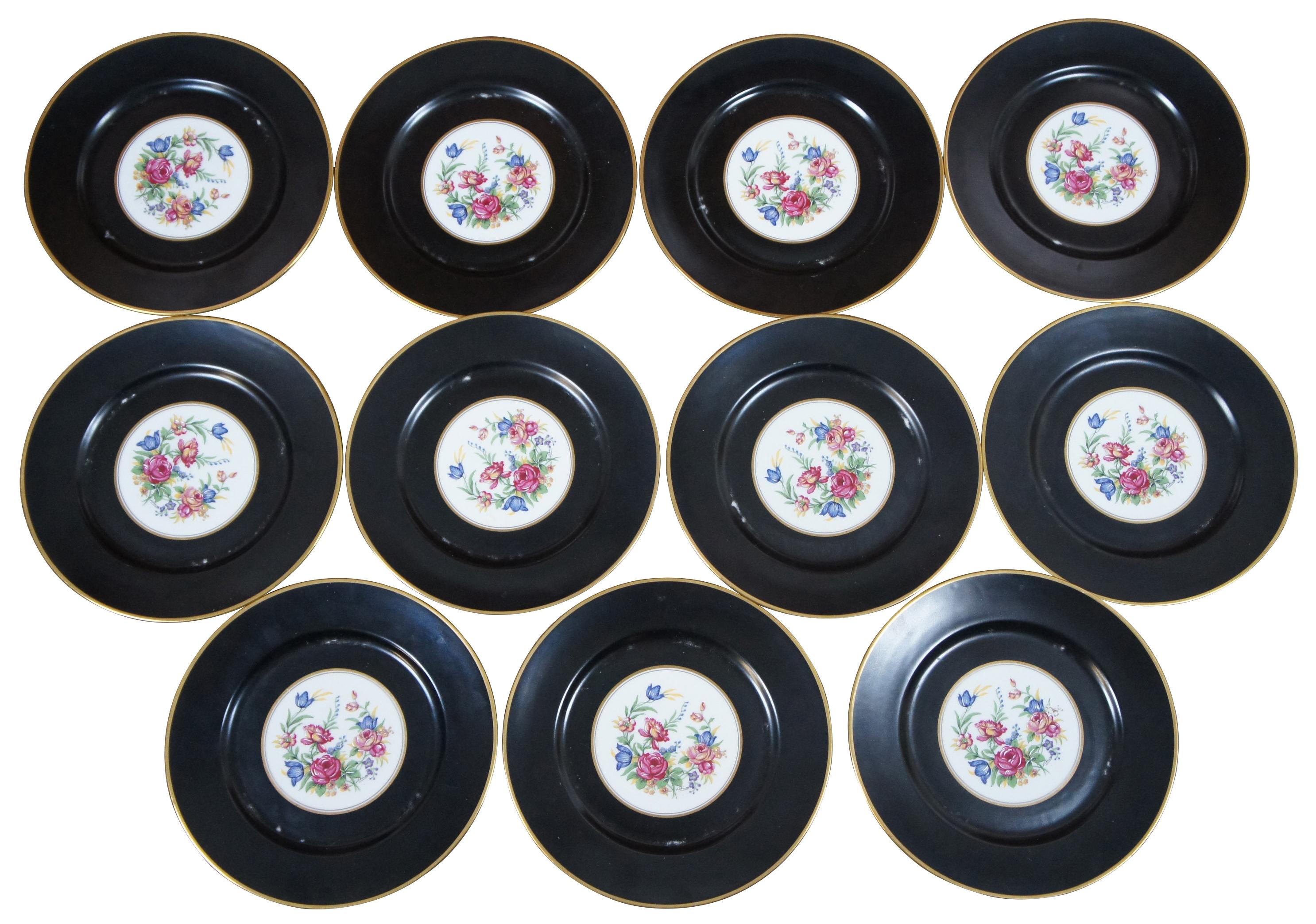 Set of eleven L. Bernardaud & Co aka B&Co Limoges porcelain dinner plates with matte black borders, floral center and gilded edges. Measure: 11