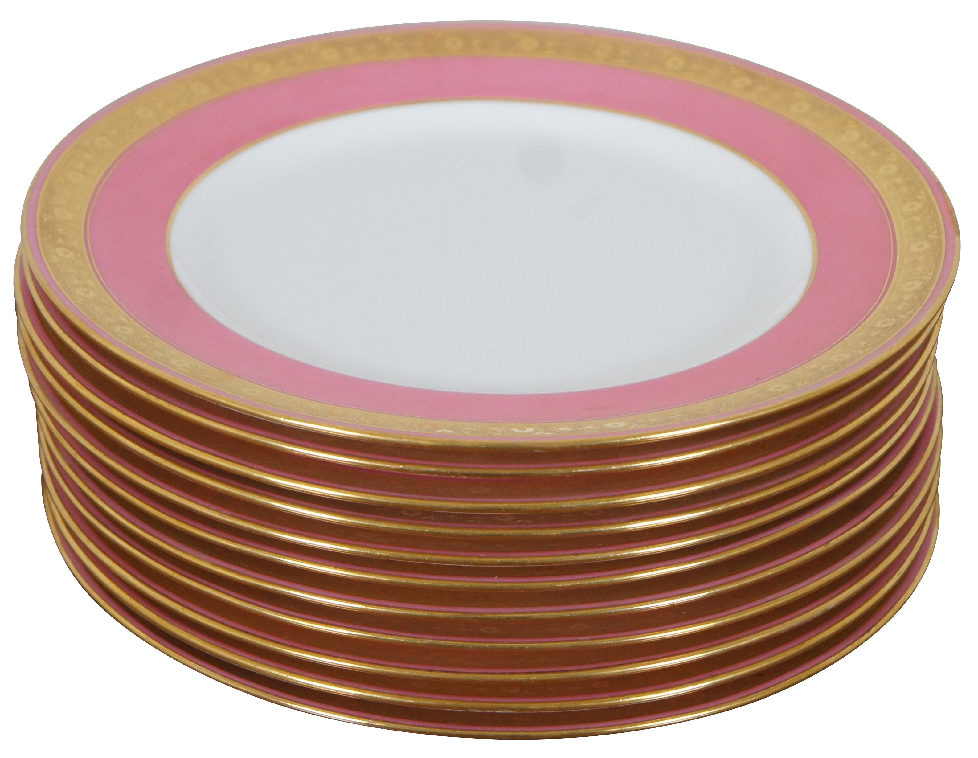 Eleven late 19th to early 20th century Minton / Davis Collamore & Company porcelain china salad plates, featuring broad pink edges with gold encrusted floral bands. Broadway & 21st New York.

