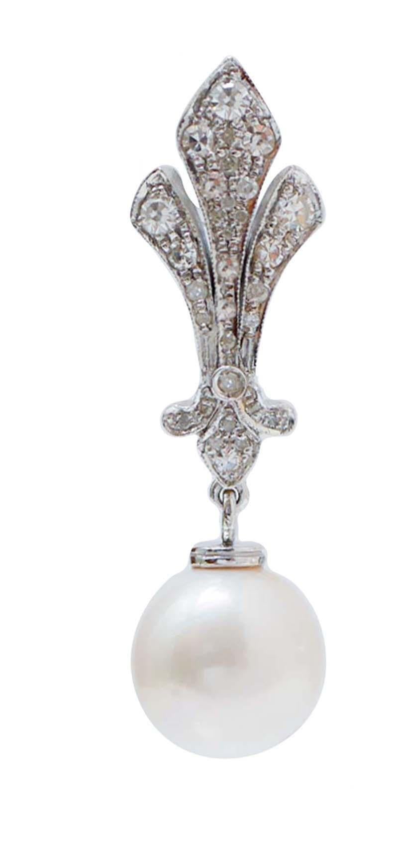 Amazing dangle earrings in 9 kt white gold structure mounted with diamonds and, as pendant, a pearl.
These earrings were totally handmade by Italian master goldsmiths and they are in perfect conditions.
Diamonds 0.95 ct
Pearls 4.10 gr
Total Weight
