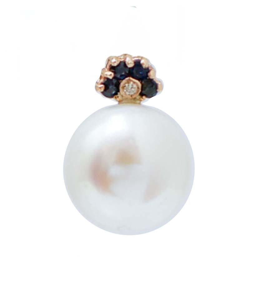 Fantastic earrings in 14 kt rose gold structure mounted, in the upper part, with blue sapphires and a little diamonds. As pendant, a  pearl.
Diamonds 0.02 ct
Blue Sapphires 0.38 ct
Pearls 3.90 gr
Total Weight 4.70 gr
RF +IHC

For any information,
