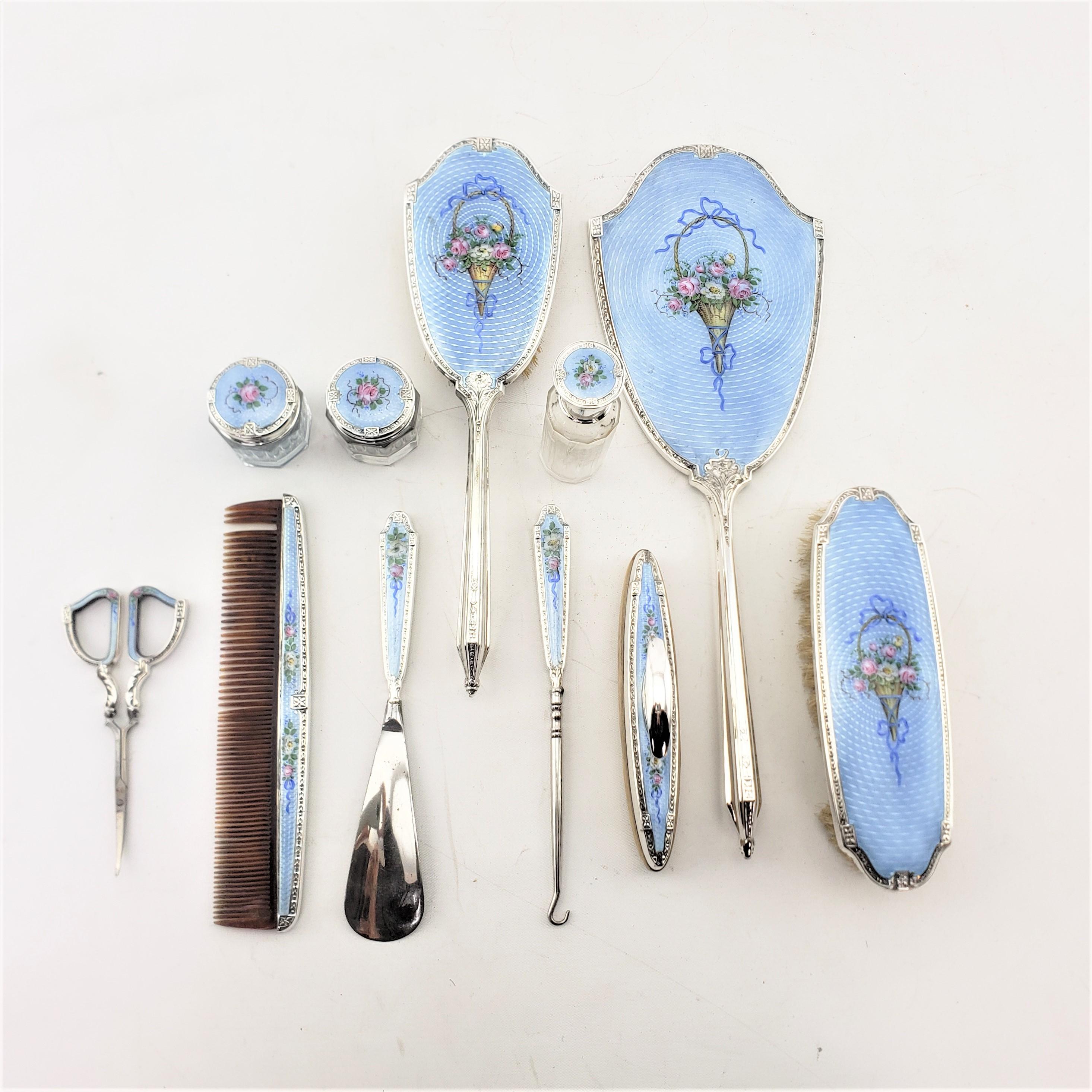 This large antique ladies dresser or vanity set is hallmarked by an unknown maker, and presumed to have originated from the United States and date to approximately 1920 and done in a period Art Deco style. The set is composed of eleven pieces, each