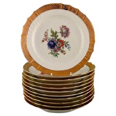 11 Royal Copenhagen Porcelain Plates with Floral Motifs and Gold Border