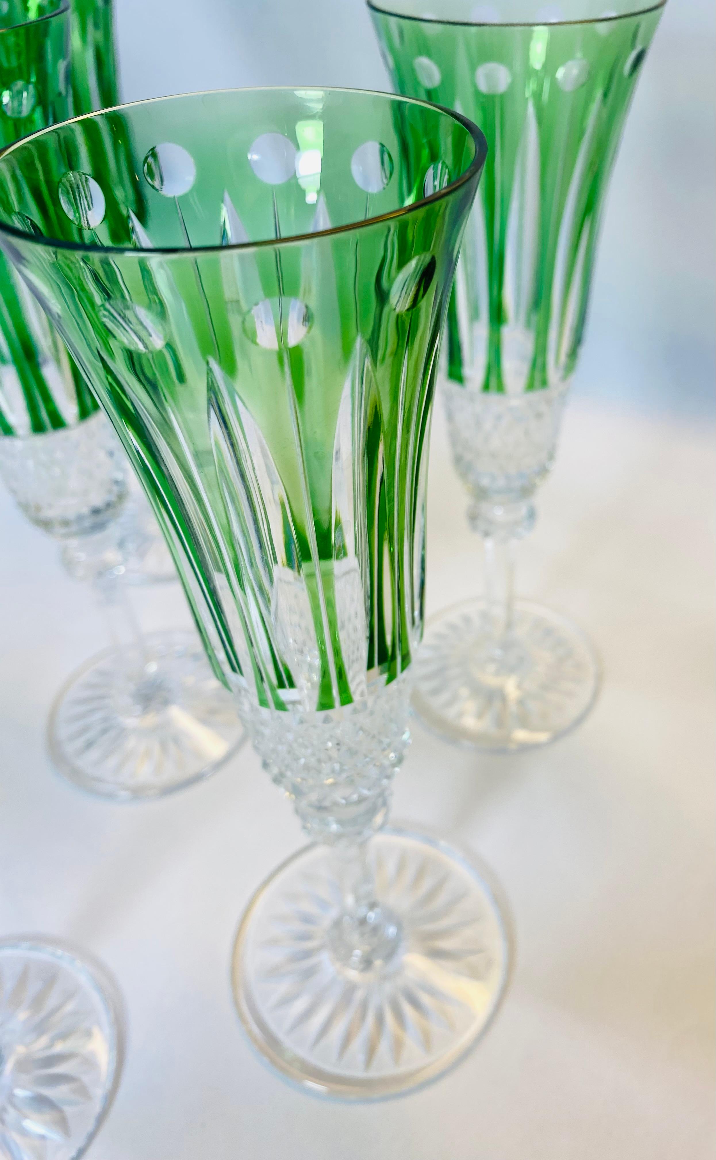 A vibrant and classic set of crystal champagne flutes from the re known factory of Saint Louis. These versatile glasses feature rich cased green glass with a fully cut knob stem and cut base. In wonderful vintage condition they will mix and match in