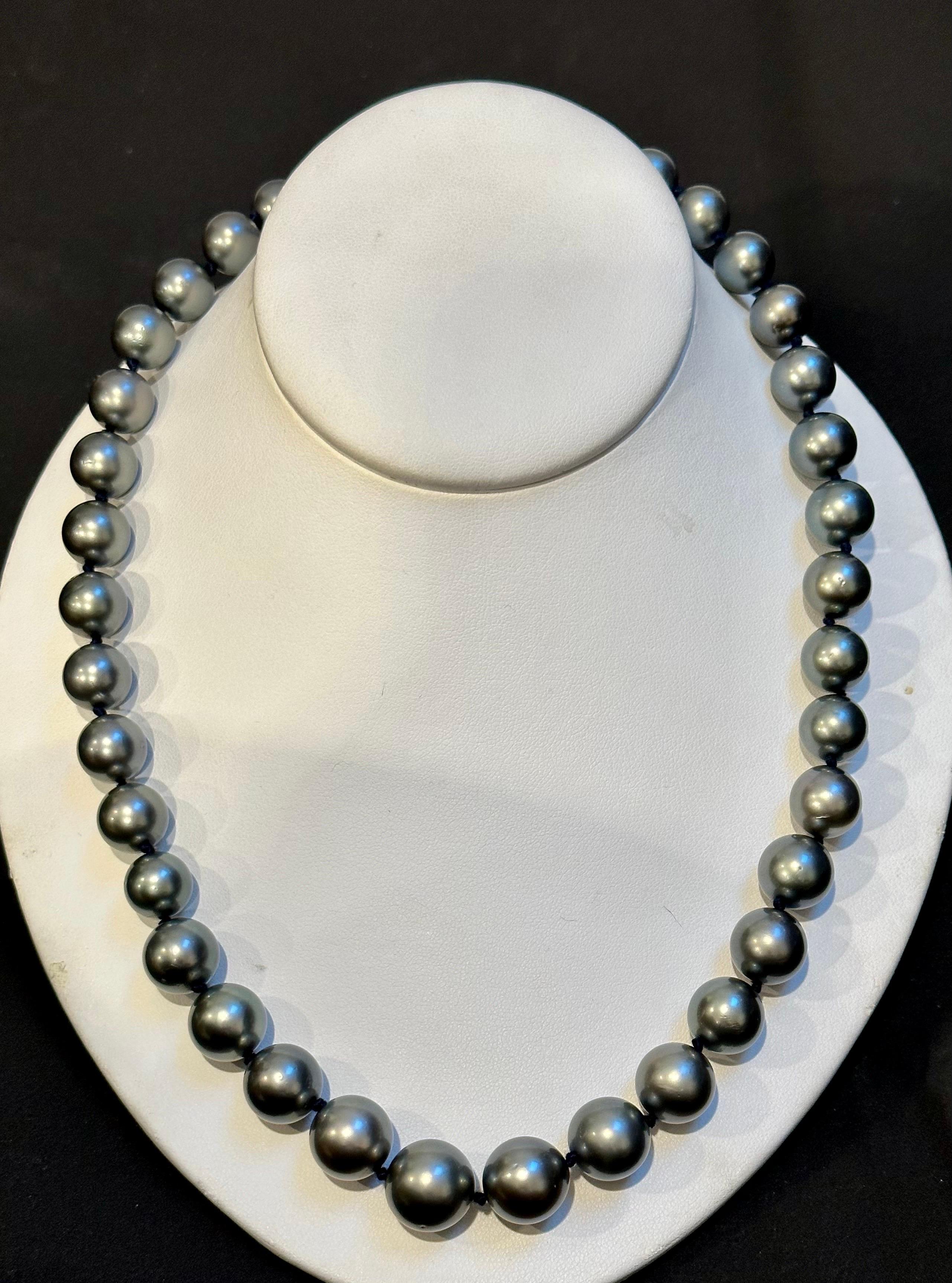 If you're in the market for a truly exceptional piece of jewelry, look no further than this 11 to 15 MM Tahitian Black Graduating Pearls Strand Necklace. This estate piece is exclusive and boasts very, very fine quality, making it a true treasure to