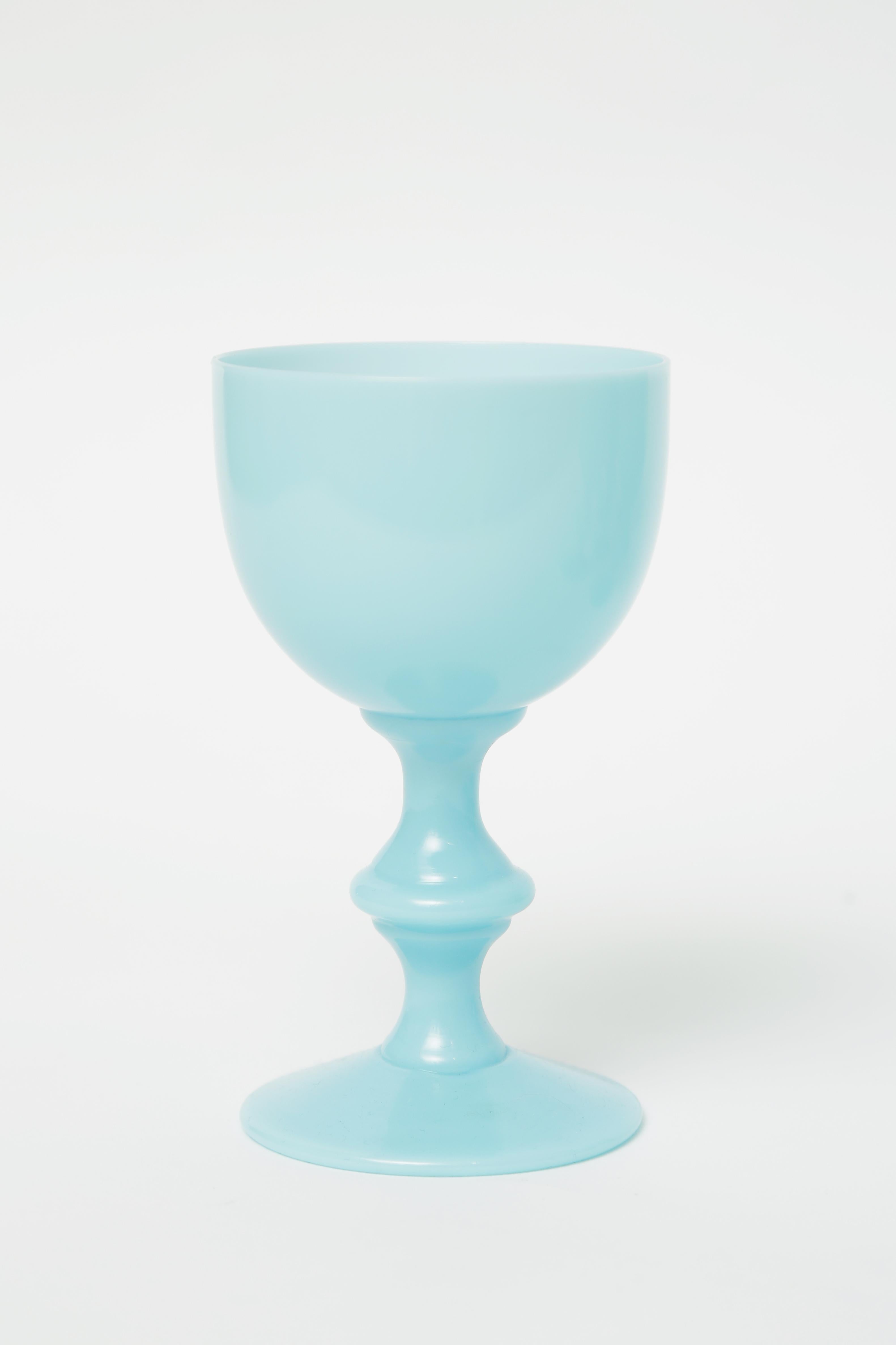 A Classic and colorful set of opaline wine glasses that have a Mid-Century Modern look. Smooth turquoise glass with a soft knob stem. Perfect for specialty cocktails and sure to pop your cabinet or kitchen display with color. In very nice vintage