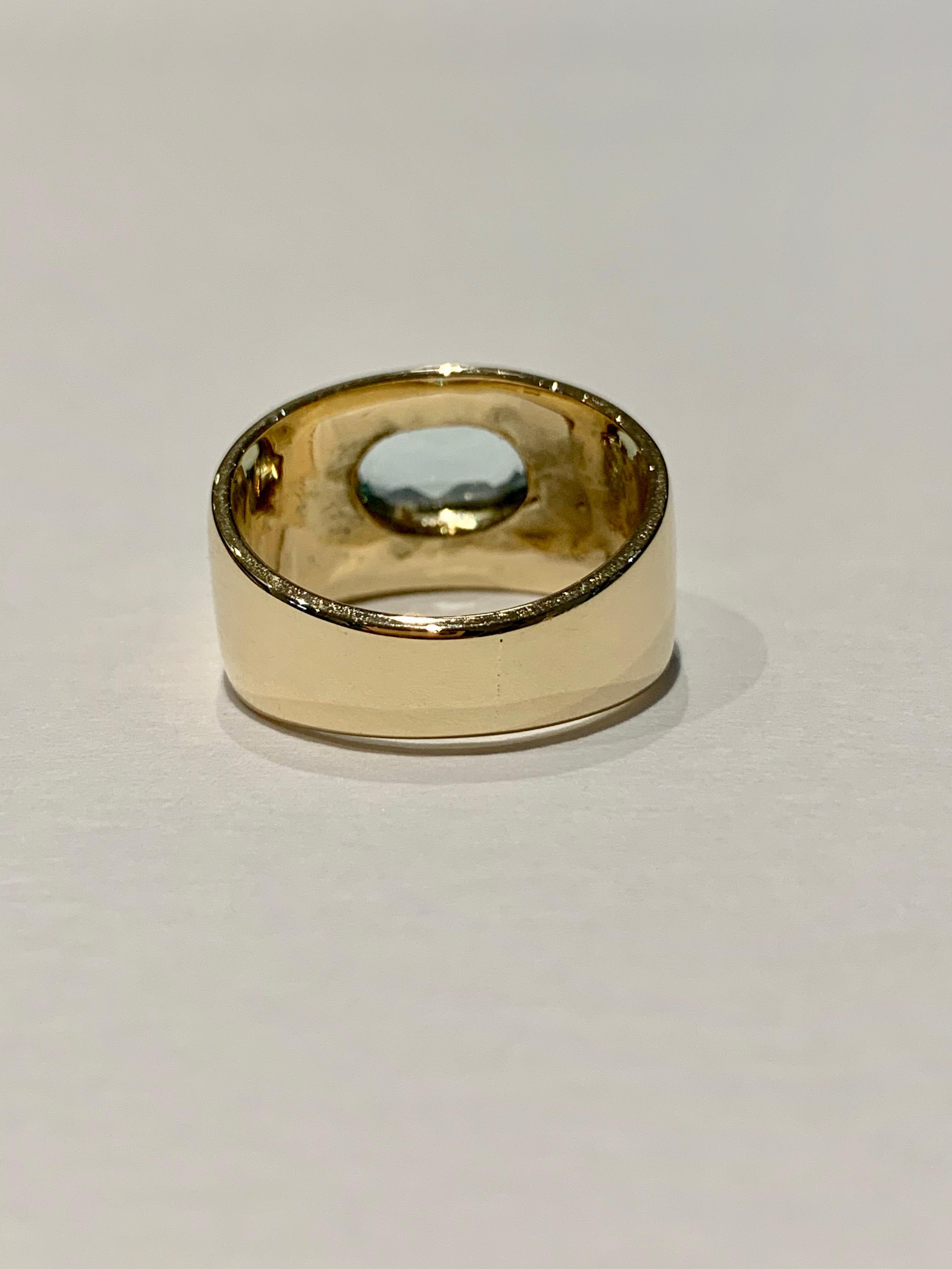 Oval Cut Oval Aquamarine in Wide 9 Carat Yellow Gold Band For Sale