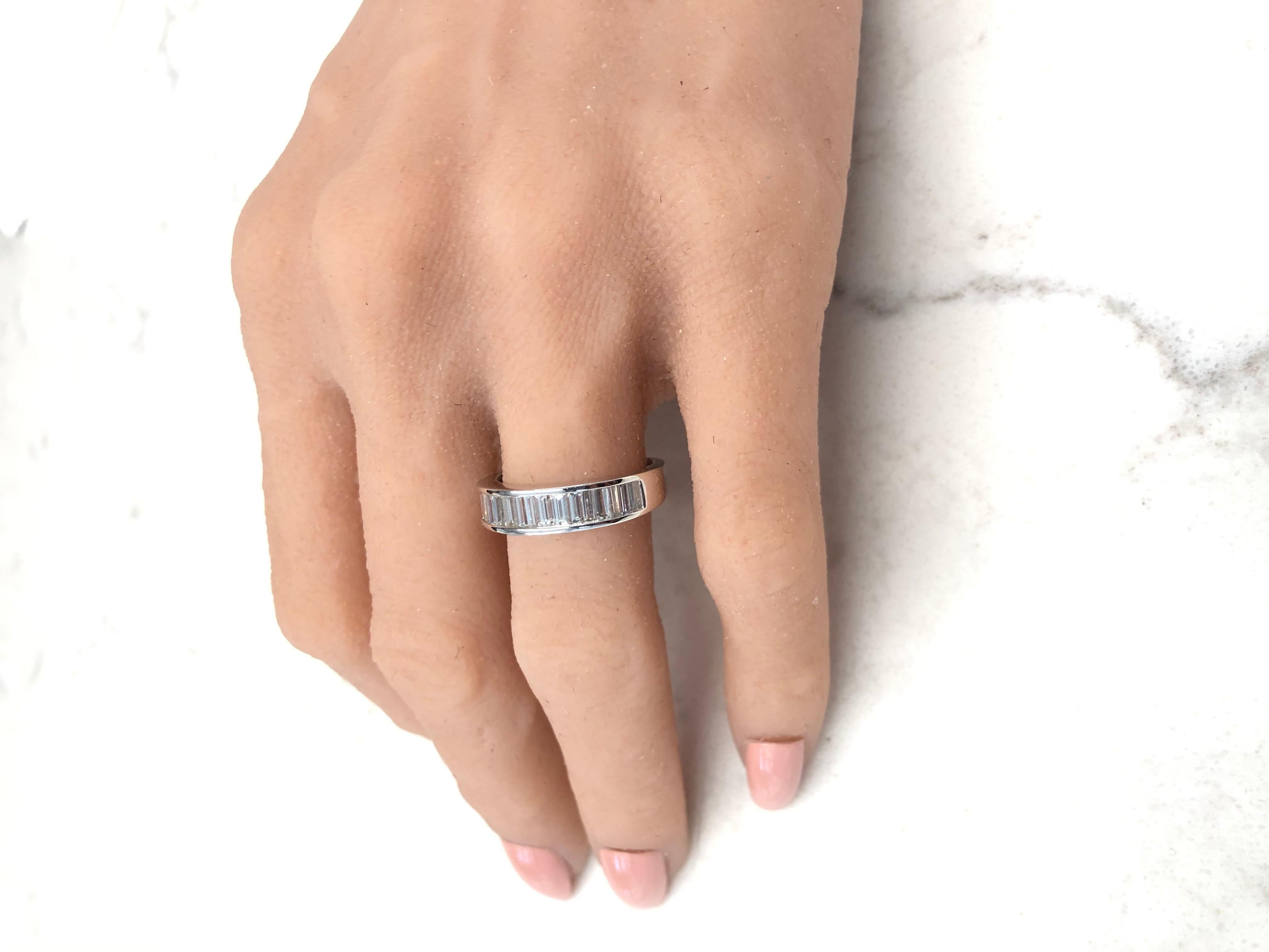 This brightly polished 14 karat white gold diamond wedding stackable ring exudes an ultimate style and prestige with its incredible sparkle and fire. A total of 1.10 carats of shimmering baguette cut diamonds are arranged in a stunning row along the