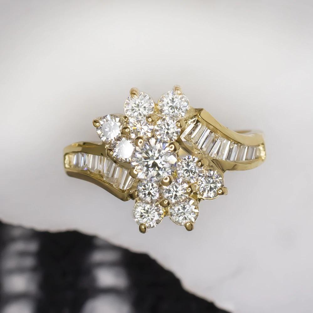 Dazzling diamond cluster cocktail ring is encrusted with 1.10 carats of brilliant and high quality diamonds! Sparkling brilliantly with a sea of exceptionally high quality diamonds, the 18k yellow gold setting has a unique and beautiful bypass