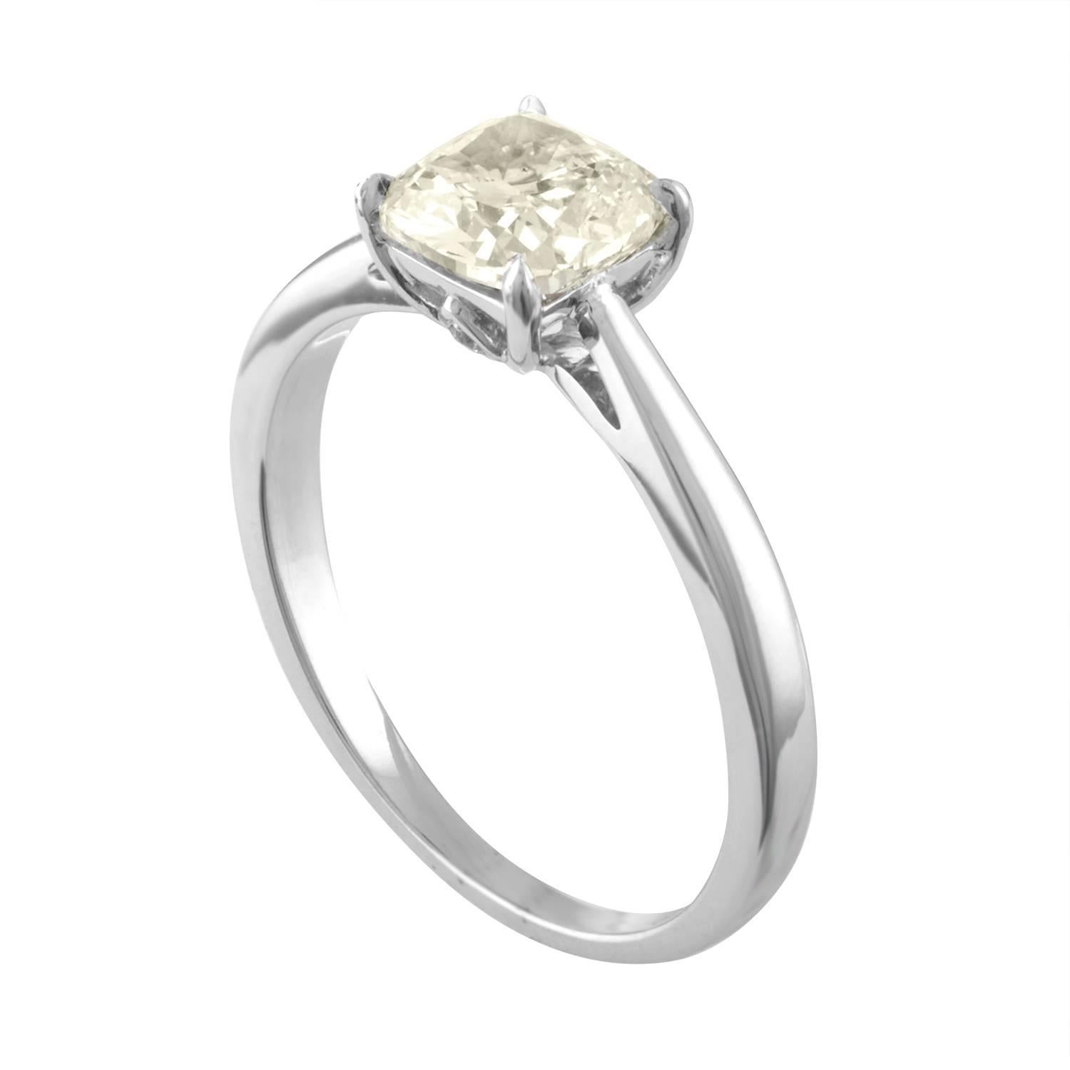 Solitaire Engagement Ring
The ring is 18K White Gold
The center is a Cushion Cut Stone 1.10 Carats K VS2
There are 2 small diamonds on the crown 0.02 Carats G VS
The ring is a size 6, sizable.
The ring weighs 2.6 grams
