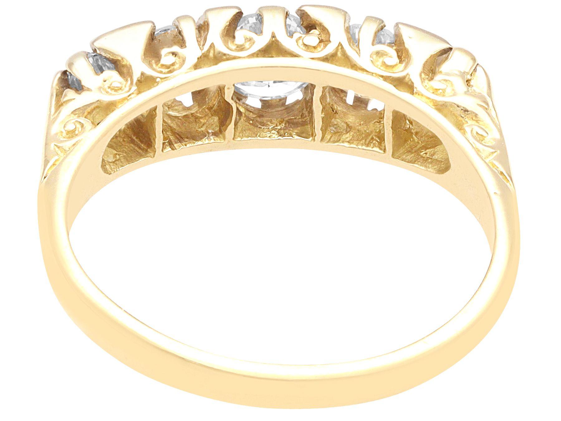 A fine and impressive vintage 1.10 carat diamond and 18 karat yellow gold five stone ring; part of our vintage estate jewelry collections.

This impressive vintage five stone diamond ring has been crafted in 18k yellow gold.

The pierced decorated,