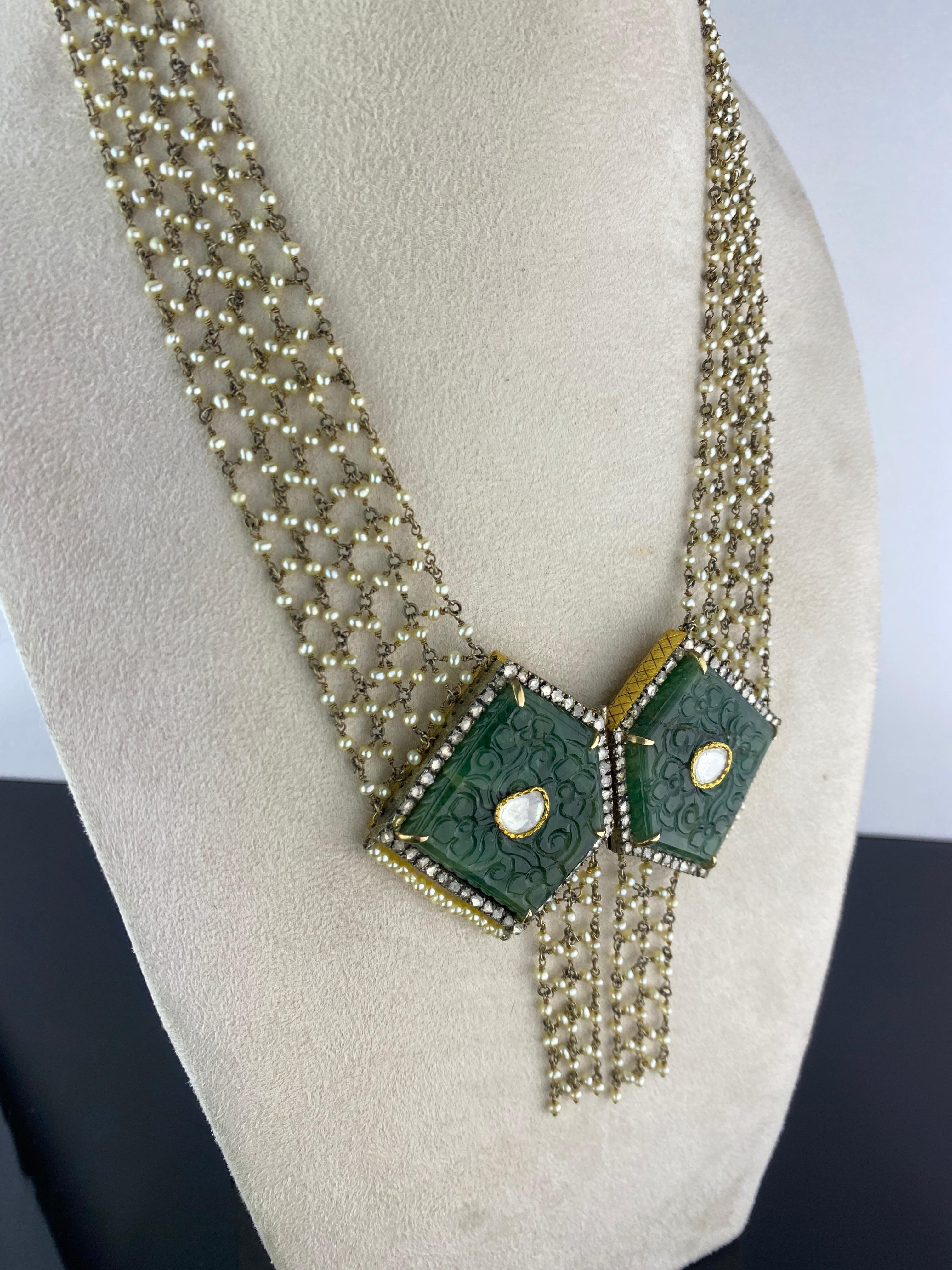 A very unique, antique looking, 110 carat Emerald (2 pieces) and rose-cut Diamond collar necklace, adorned with pearls. The necklace fastening is fro the front, making it easy to wear. The stones are set in silver, and plated in gold. 
Please feel