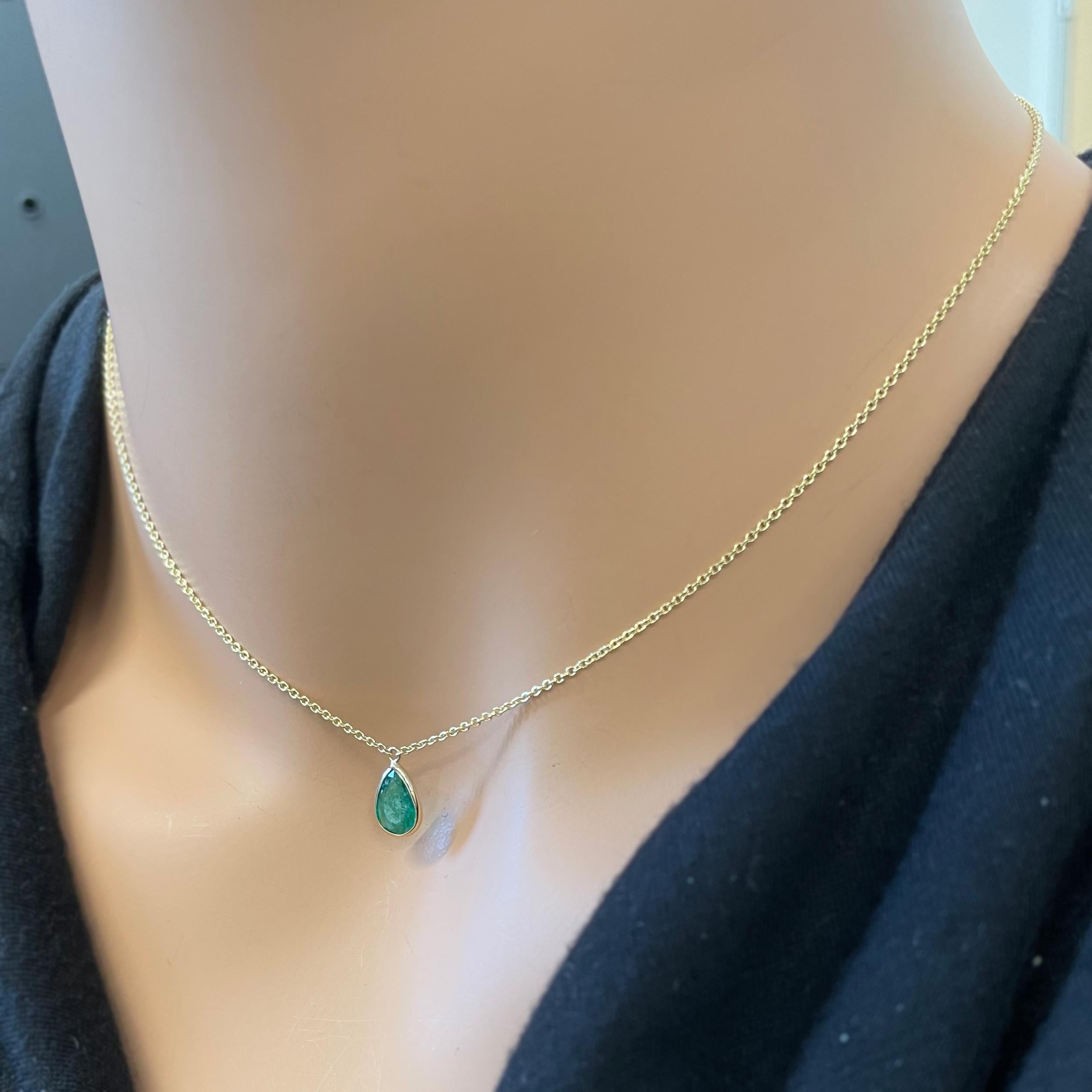 This necklace features a pear-cut green emerald with a weight of 1.10 carats, set in 14k yellow gold (YG). Emeralds are highly prized for their rich green color, and the pear cut, with its distinctive teardrop shape, adds an elegant and unique touch
