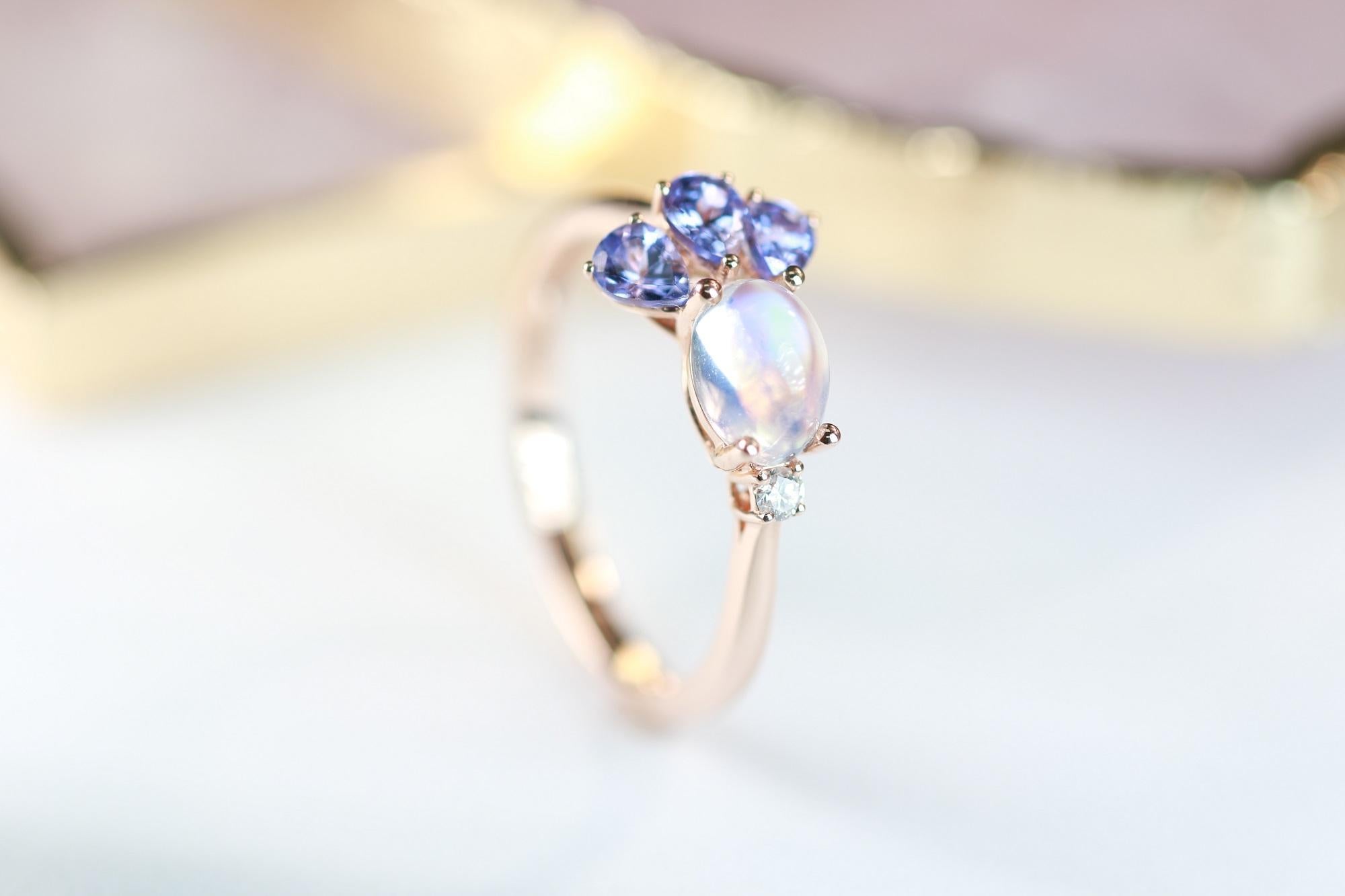 Stunning, timeless and classy eternity Unique Ring. Decorate yourself in luxury with this Gin & Grace Ring. The 14k Rose Gold jewelry boasts Oval Cab Prong Setting Genuine moonstone  (1 pcs) 0.57 Carat, Pear cut Tanzanite (3 pcs) 0.53 carat along