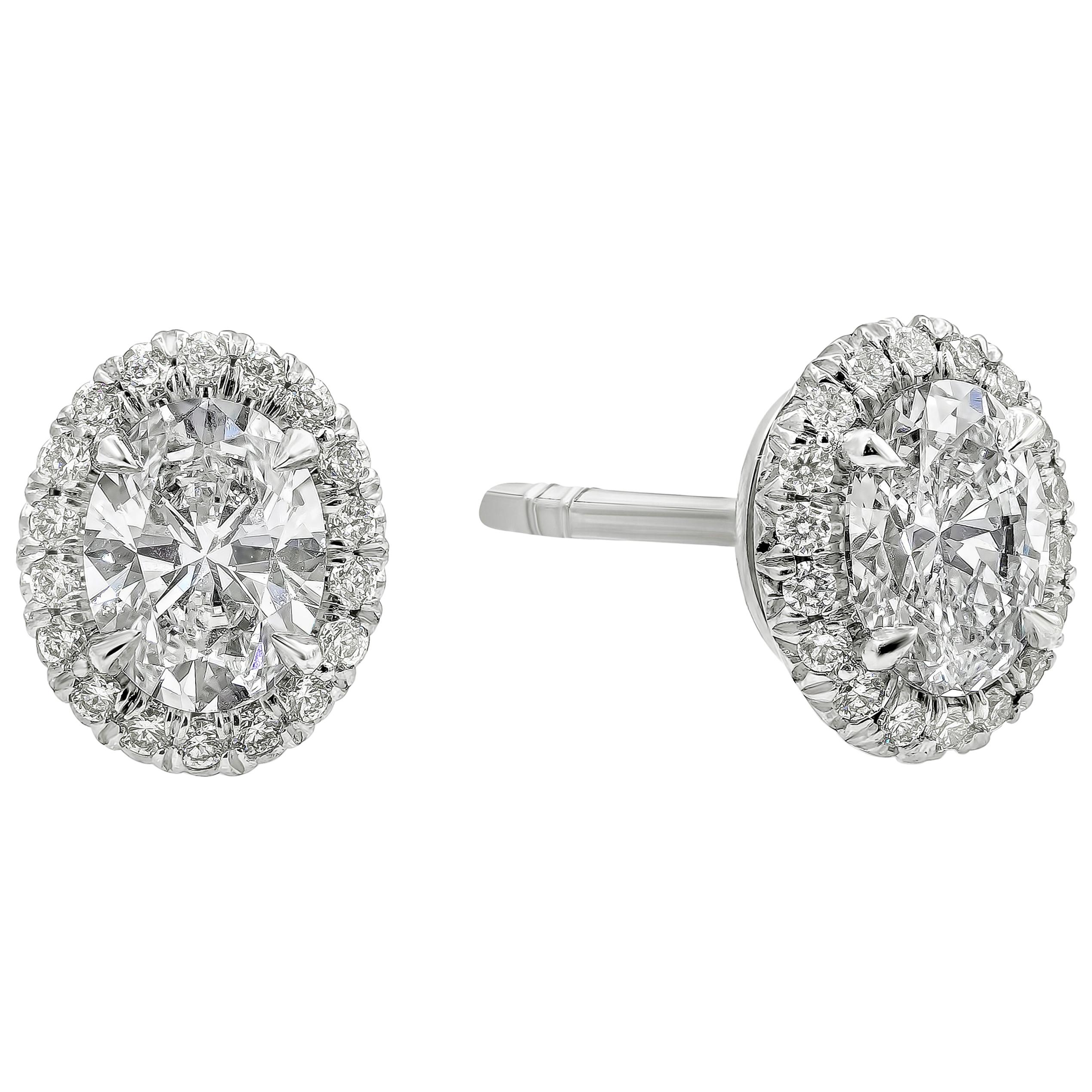 A simple and classic halo stud earrings showcasing a 0.95 carats total oval cut diamonds, G Color and VS in Clarity. Surrounded by a single row of round brilliant diamonds weighing 0.15 carats total. Made with Platinum.

Style available in different