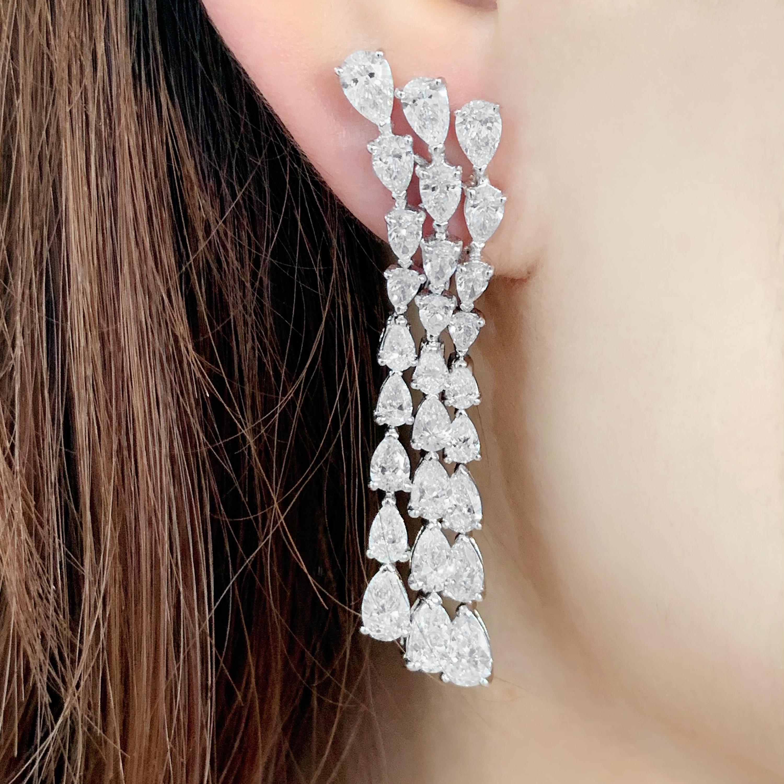 Butani's one-of-a-kind three row diamond chandelier earrings feature a cascade of 54 shimmering pear-cut diamonds totaling 11.0 carats.  Set in 18K white gold.  Show them off with swept-back hair.

Composition: 
18K White Gold 
54 Pear Diamonds: