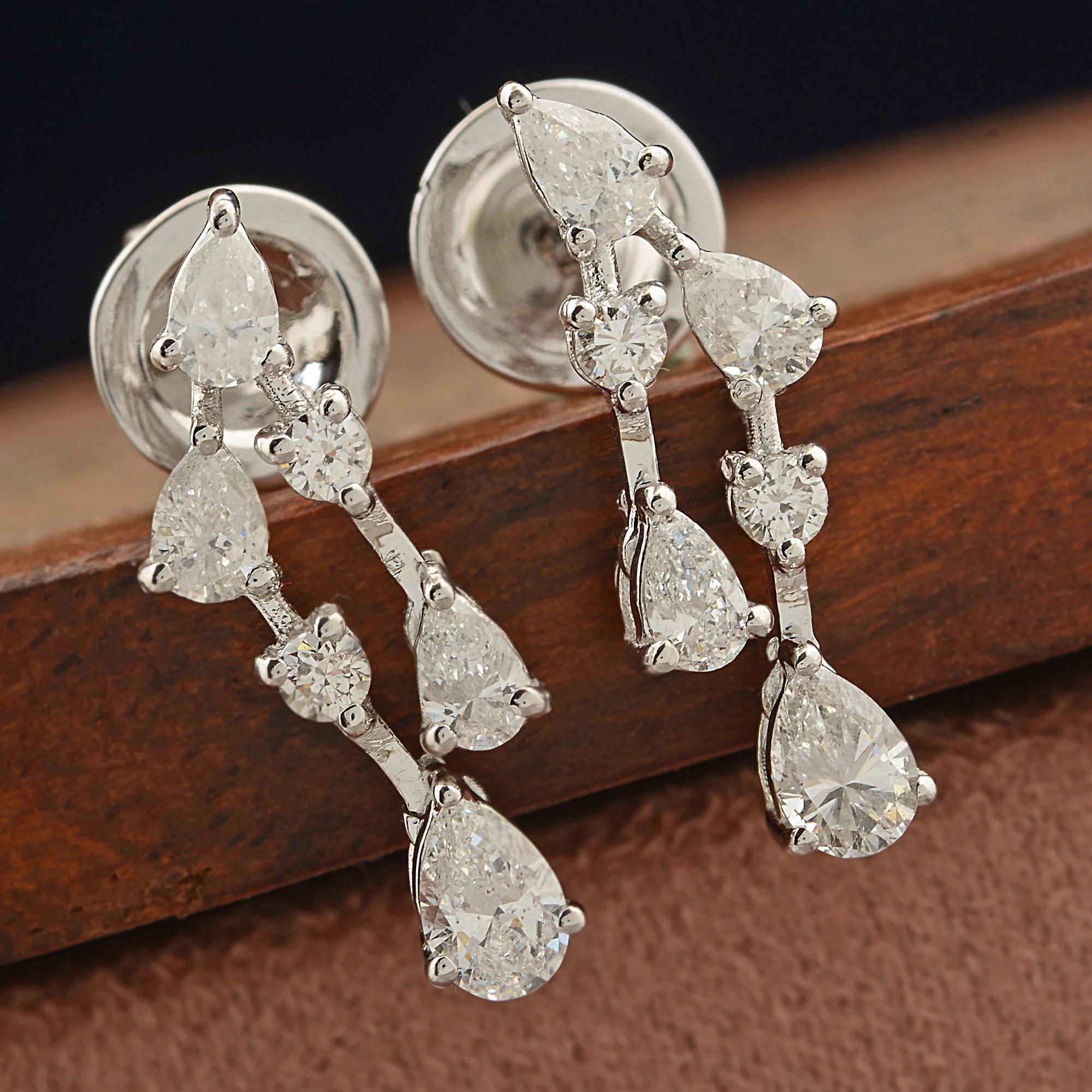 Indulge in the epitome of elegance with these exquisite 1.10 Carat Pear & Round Diamond Dangle Earrings crafted in 14 Karat White Gold. Radiating sophistication and glamour, these dainty yet dazzling earrings are a testament to fine jewelry