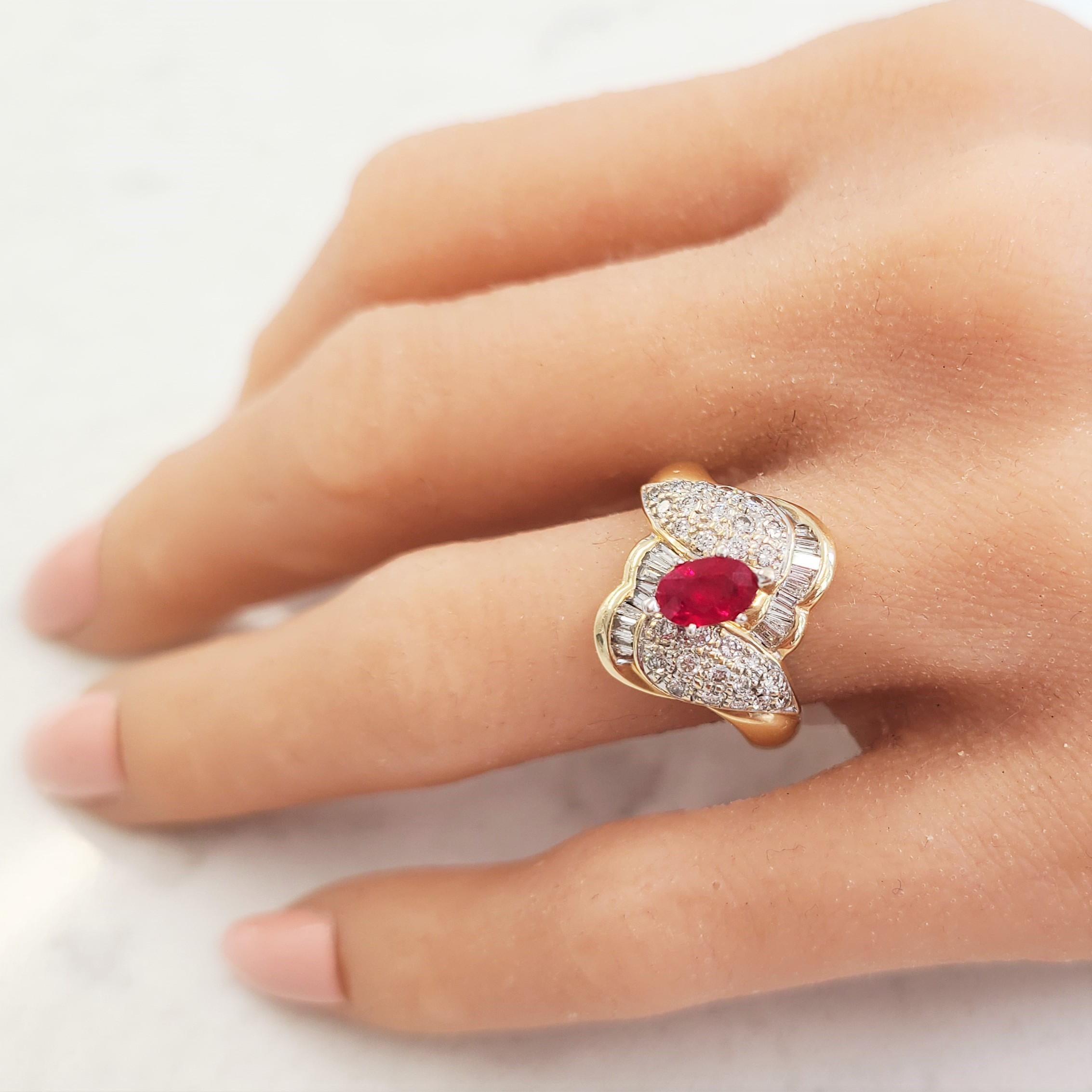 This gorgeous brightly polished 14 karat yellow gold cocktail engagement anniversary ring features a stunning combination of ruby and diamonds, creating a spectacular showing of vibrancy and fire. A center-set 0.50 carats of ruby is set into this
