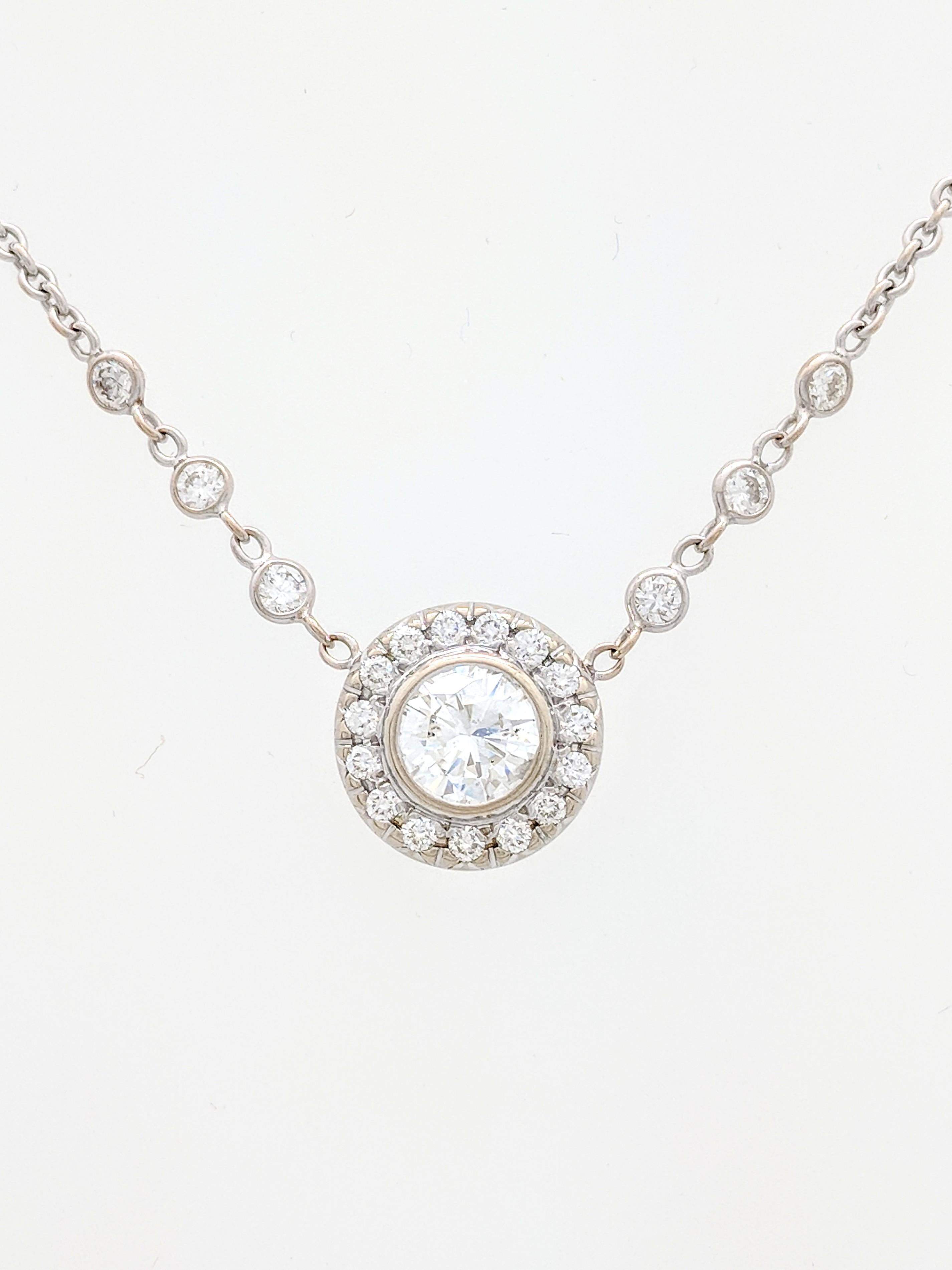 You are viewing a stunning diamond halo pendant necklace.

This pendant is crafted from 18k white gold and weighs 8.3 grams. It features approximately (1) 1.10ct natural round brilliant cut diamond surrounded by a halo of (15) .03ct round natural