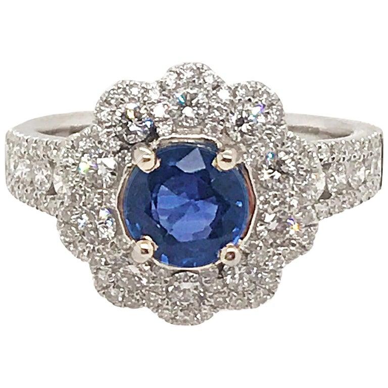 Stunning 18kt White Gold Ring set with a Round Cut Sapphire that is 1.10 carat. 
130 Round Brilliant Cut Diamonds totaling .95 carats. The setting is masterfully crafted. A beautiful combination of brilliance, color and detail flowing in this 18