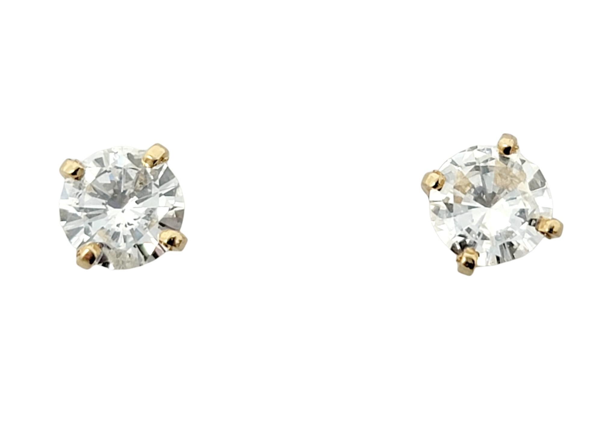 Utterly timeless diamond solitaire stud earrings. These gorgeous round diamond and yellow gold pierced ear studs are the epitome of minimalist elegance. They give just the right hint of sparkle for everyday wear and the classic design ensures they