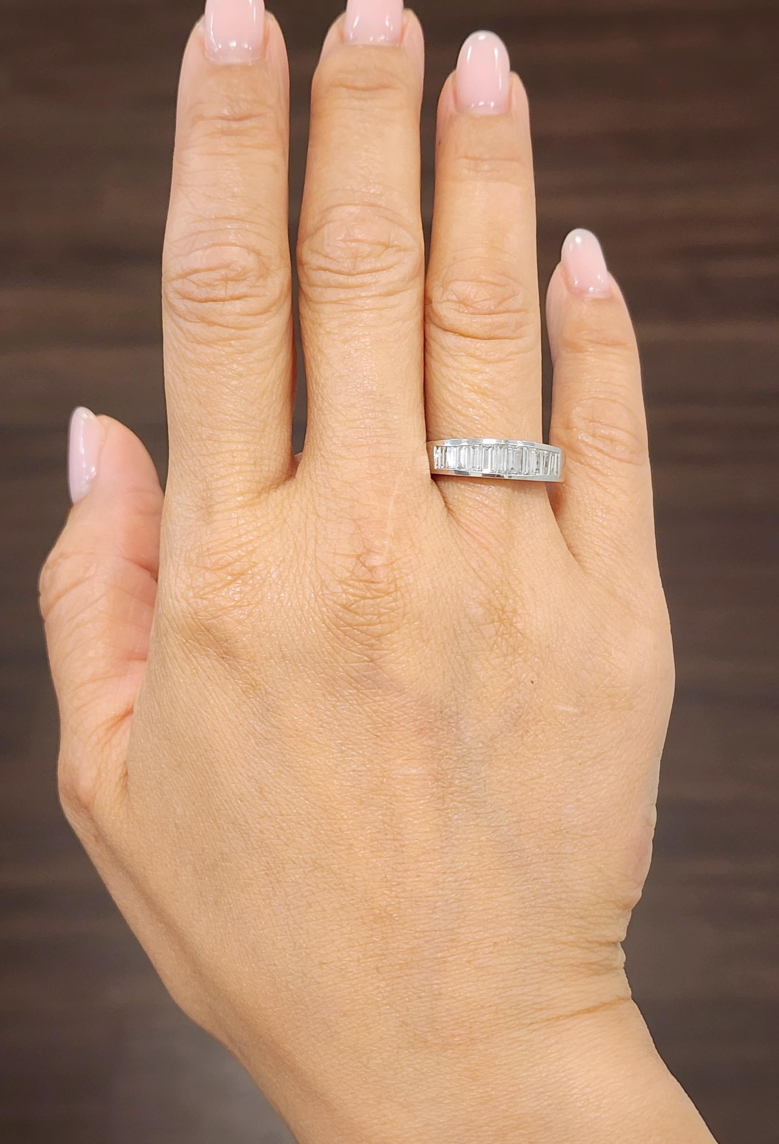 This elegant band ring is crafted from 14k white gold and features approximately 1.10 carats of baguette-cut diamonds. The diamonds are white, with a clarity of VS1/VS2 and a color grade of G/H. Designed in a modern style, the ring is a size 6.5 and