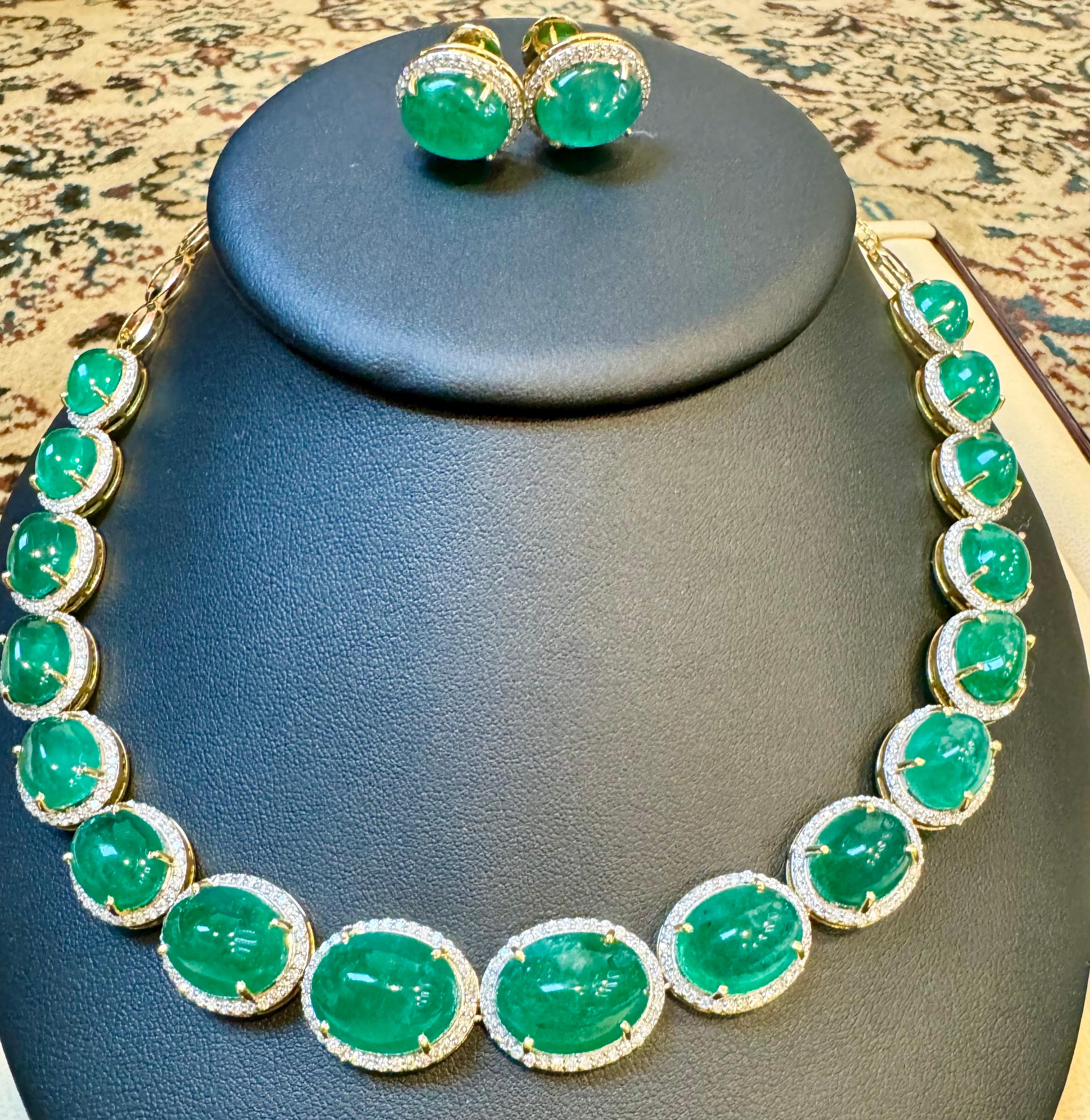 110 Ct Oval Natural Cabochon Emerald & Diamond Necklace Suite set in 14 Karat Yellow Gold is a stunning piece. This necklace showcases 17 natural cabochon emeralds, each encircled by brilliant cut diamonds. The matching stud post earrings complement