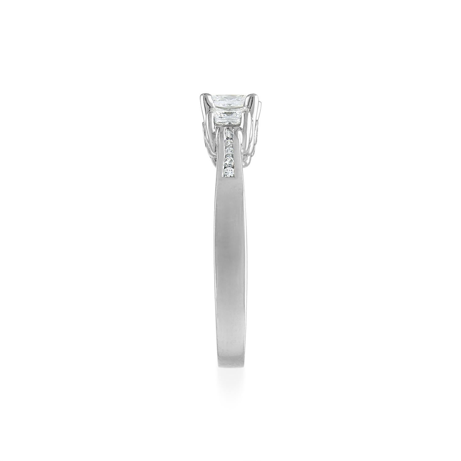 1.10 Ct Total Weight, Platinum Diamond Ring, Princess cut center stones
Three center Princess cut diamonds, accented by 16 Diamonds set in the shank and gallery.

Metal: Platinum
Diamond Shape: Princess cut, and Round Brilliant
Total Diamond Weight: