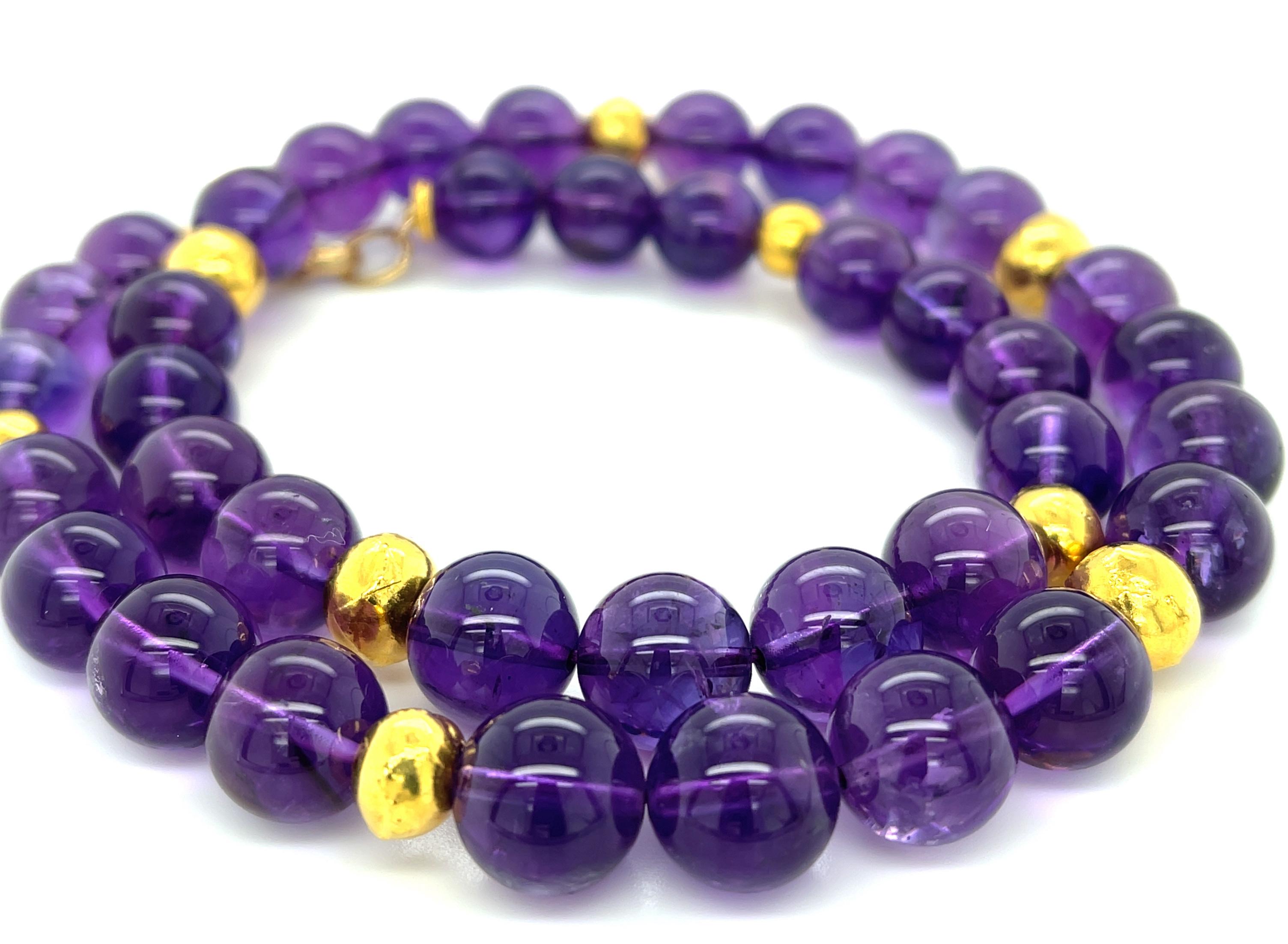 This unusually fine quality necklace features a beautifully matched collection of amethyst beads with stunning royal purple color. The beads measure 11.00 - 11.50mm and are arranged with elegant, textured 18k yellow gold beads that make this a