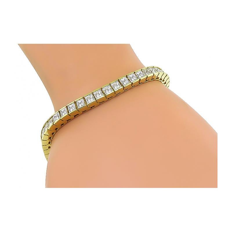 This is a stunning 14k yellow gold bracelet. The bracelet is set with sparkling princess cut diamonds that weigh approximately 11.00ct. The color of these diamonds is F-G with VS clarity. The bracelet measures 4.5mm in width and 7 inches in length.