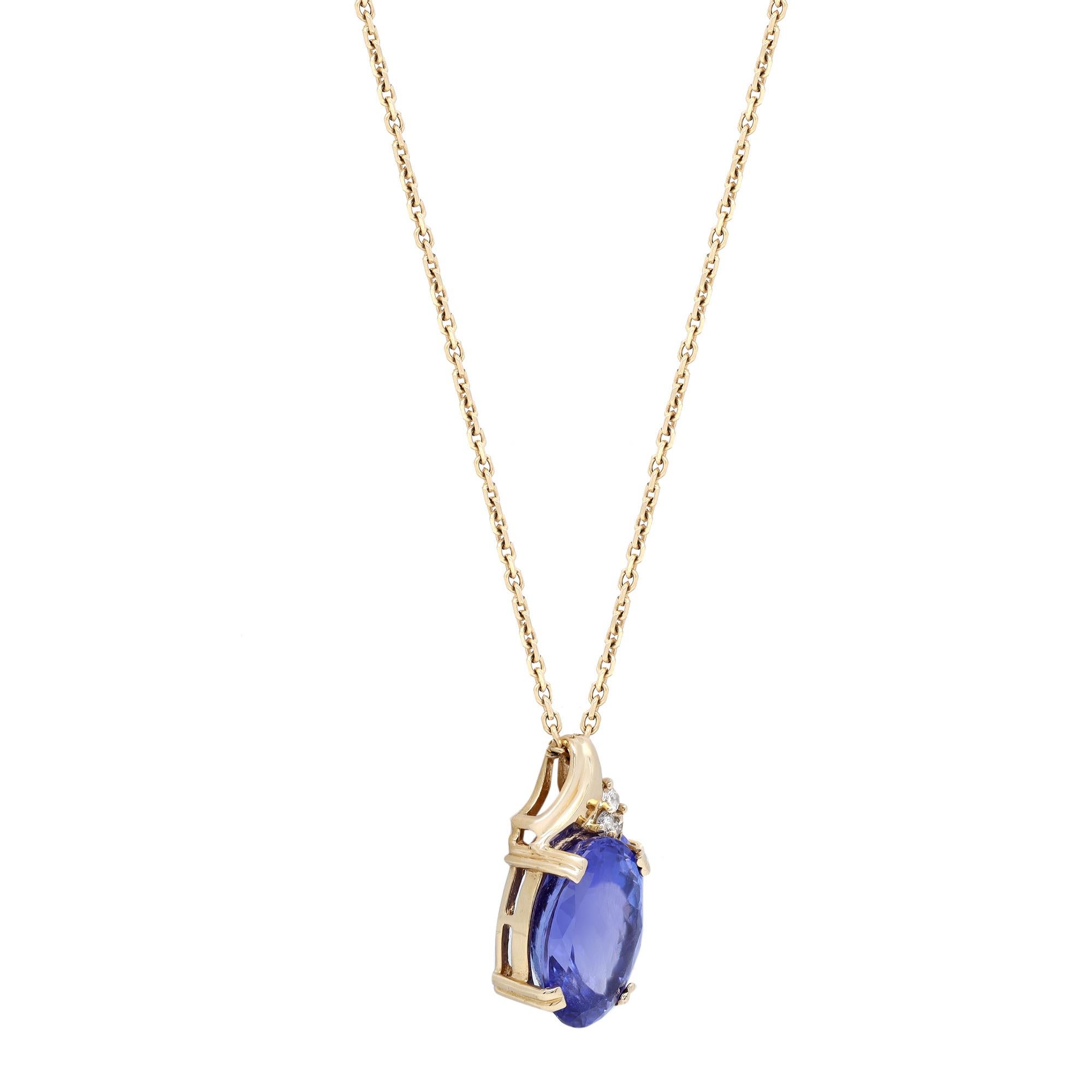 This beautiful Tanzanite and diamond pendant necklace is crafted in 14K yellow gold. The pendant features prong set 11.00 carats of oval shaped Tanzanite and 0.09 carat of round cut diamonds. Necklace length: 18 inches. Total weight: 9.55 grams.