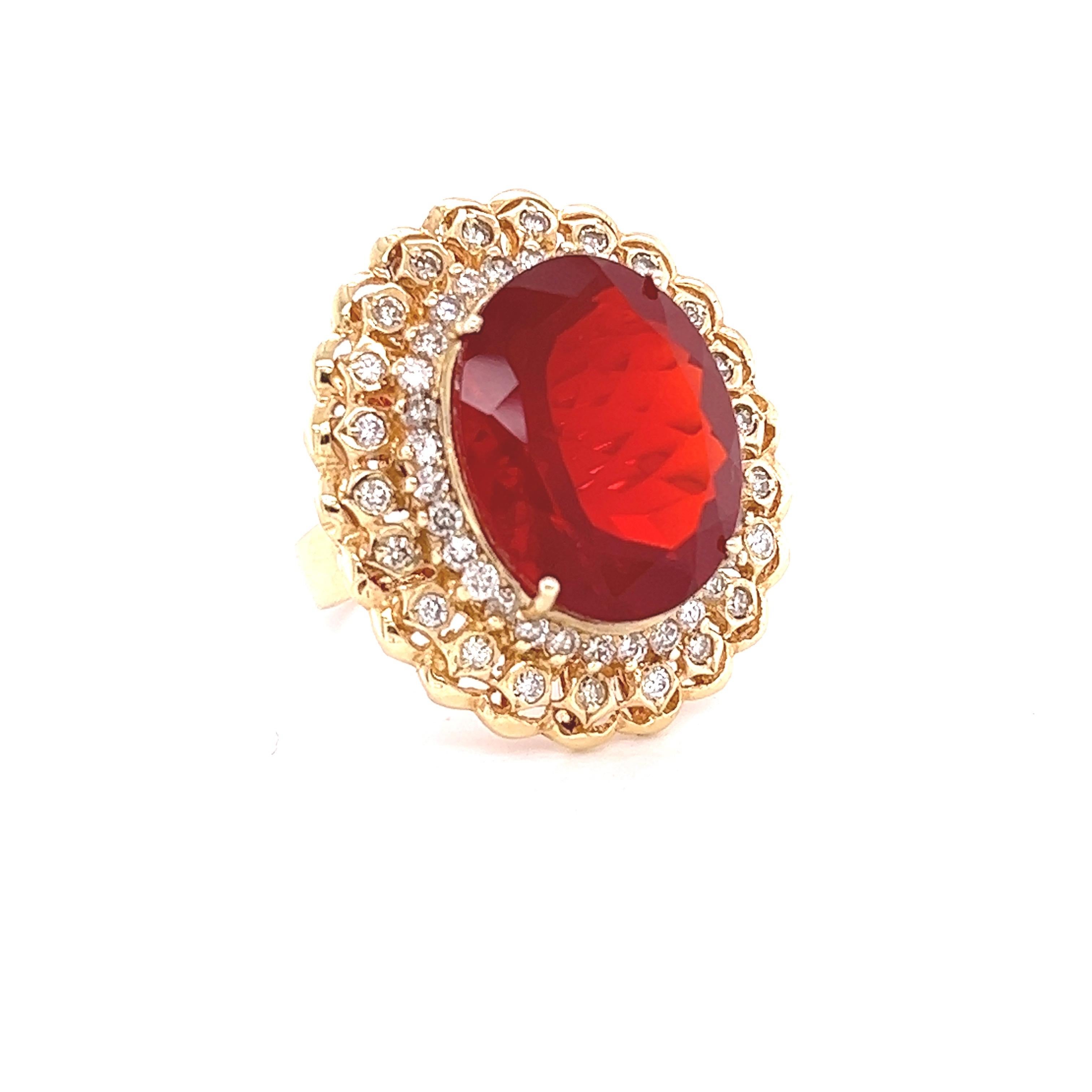 The Red Oval Cut Fire Opal weighs 10.01 Carats and has 53 Round Cut Diamonds that weigh 1.03 Carats. The clarity and color of the diamonds are VS-H. The total carat weight of the ring is 11.04 Carats. The Fire Opal has its origins from Mexico and