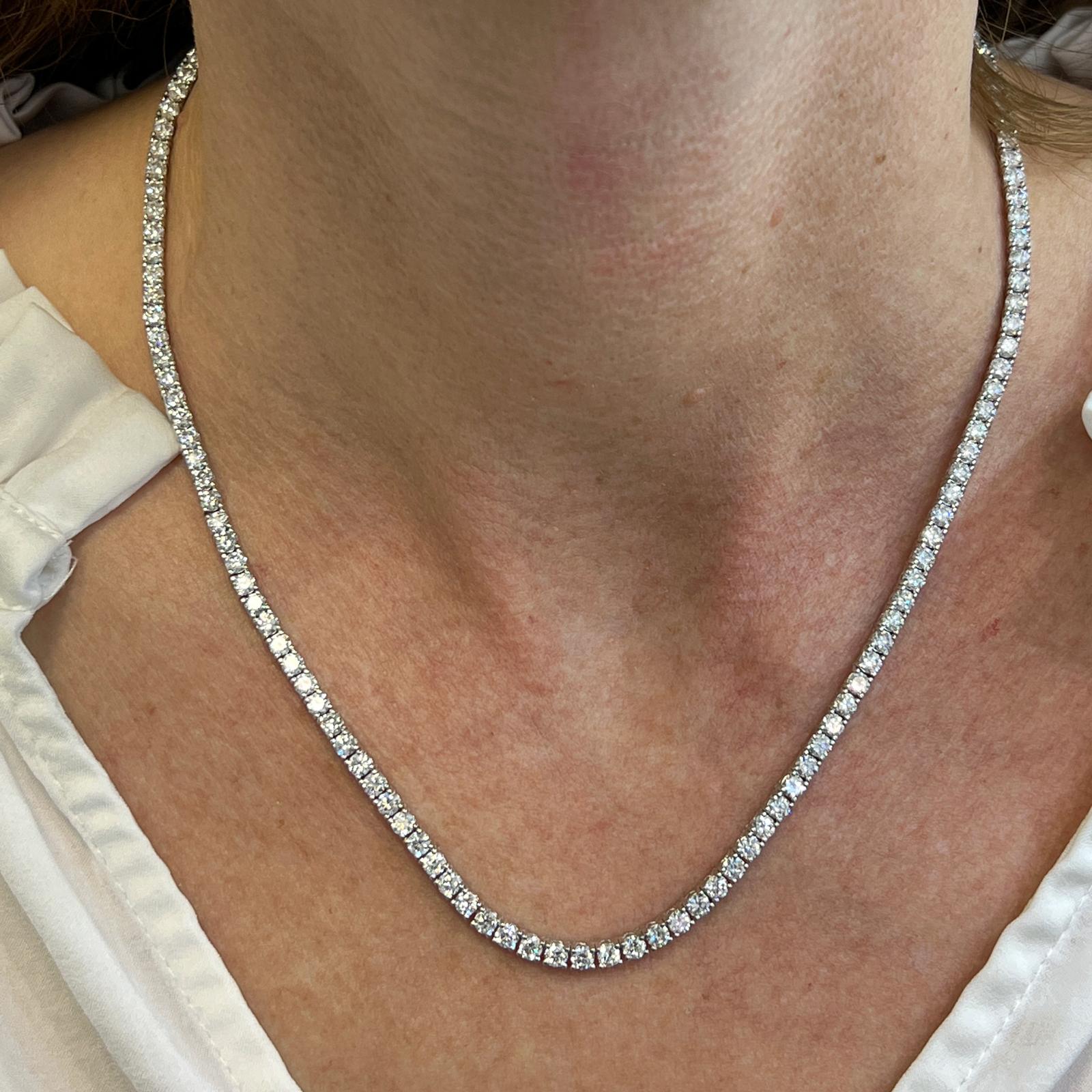Stunning new diamond tennis necklace crafted in 14 karat white gold. The necklace features 136 round brilliant cut diamonds weighing 11.04 carat total weight. The diamonds are brilliant and graded H-I color and SI clarity. The necklace measures 16