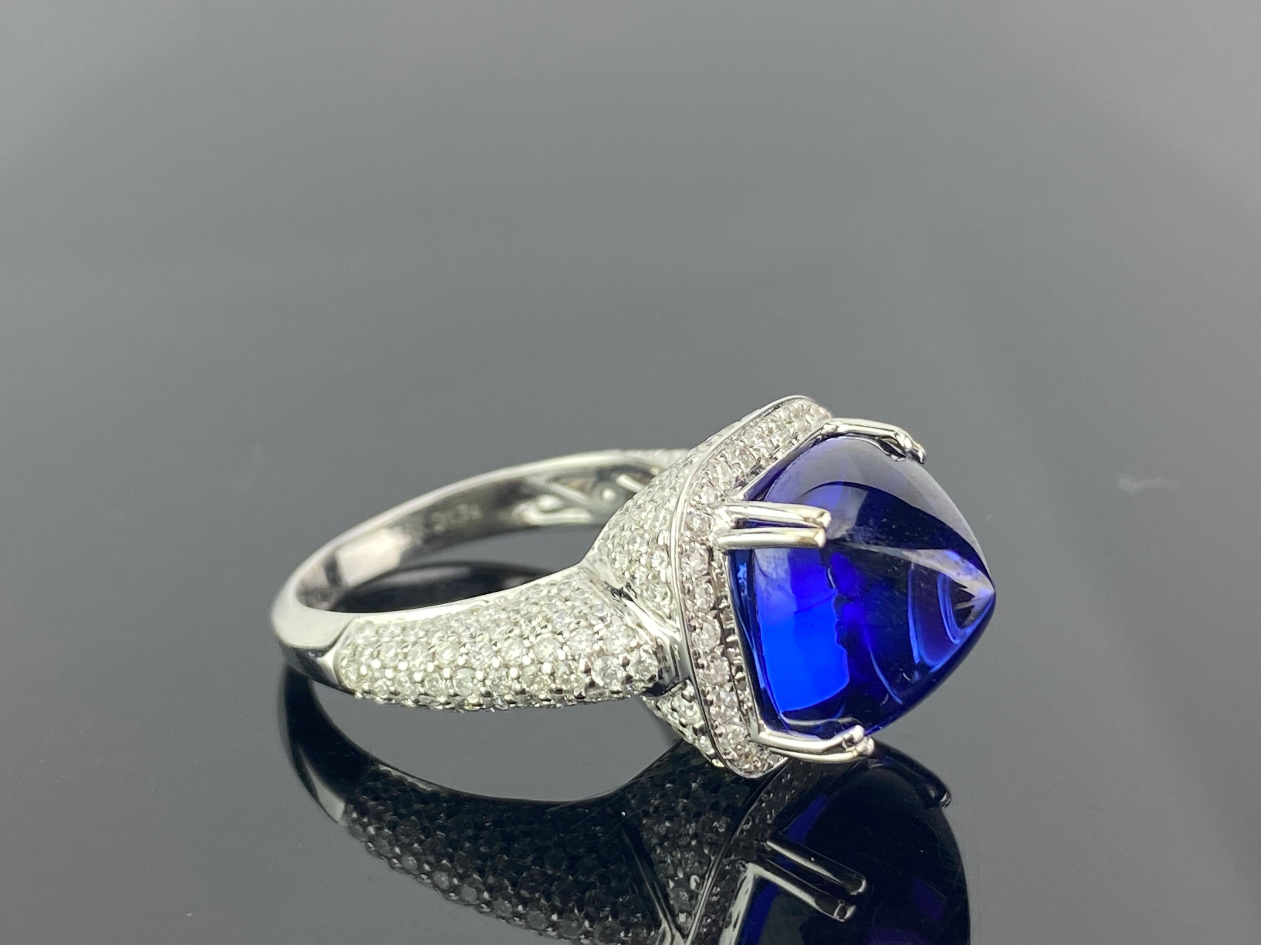 A stunning, natural sugarloaf shaped Tanzanite ring, with Diamonds set in 18K white gold. 
The stone is transparent, with no inclusions at all, the stone is a strong/vivid blue without a purple hue. We used a top quality centre stone for this ring.