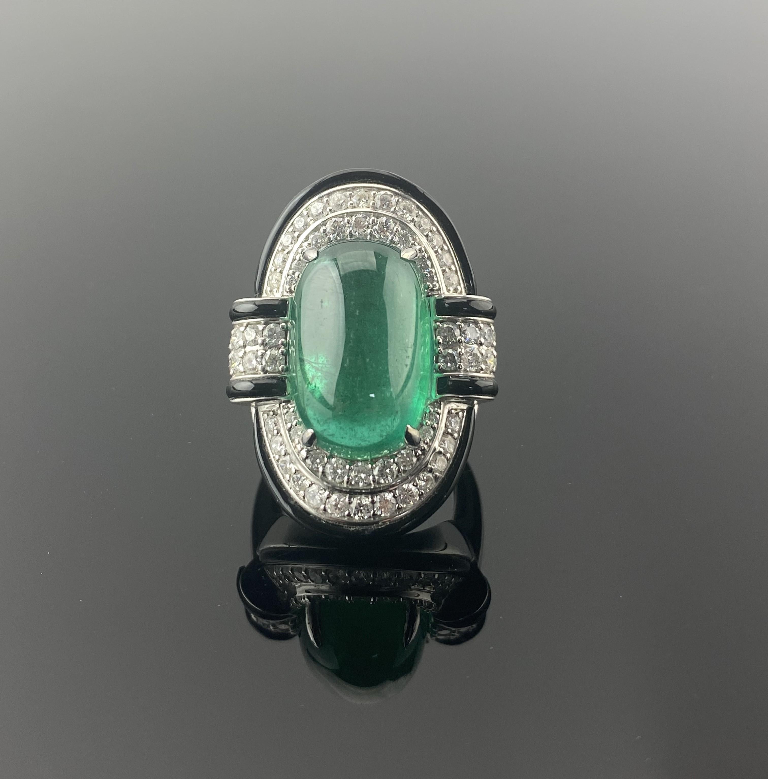 Make a statement with this stunning art-deco inspired 11.08 carat long cushion shaped Zambian Emerald cabochon, 1.56 carat White Diamond and 7.60 carat Black Onyx cocktail ring. All set in solid 18K White Gold. The center stone Emerald is of very