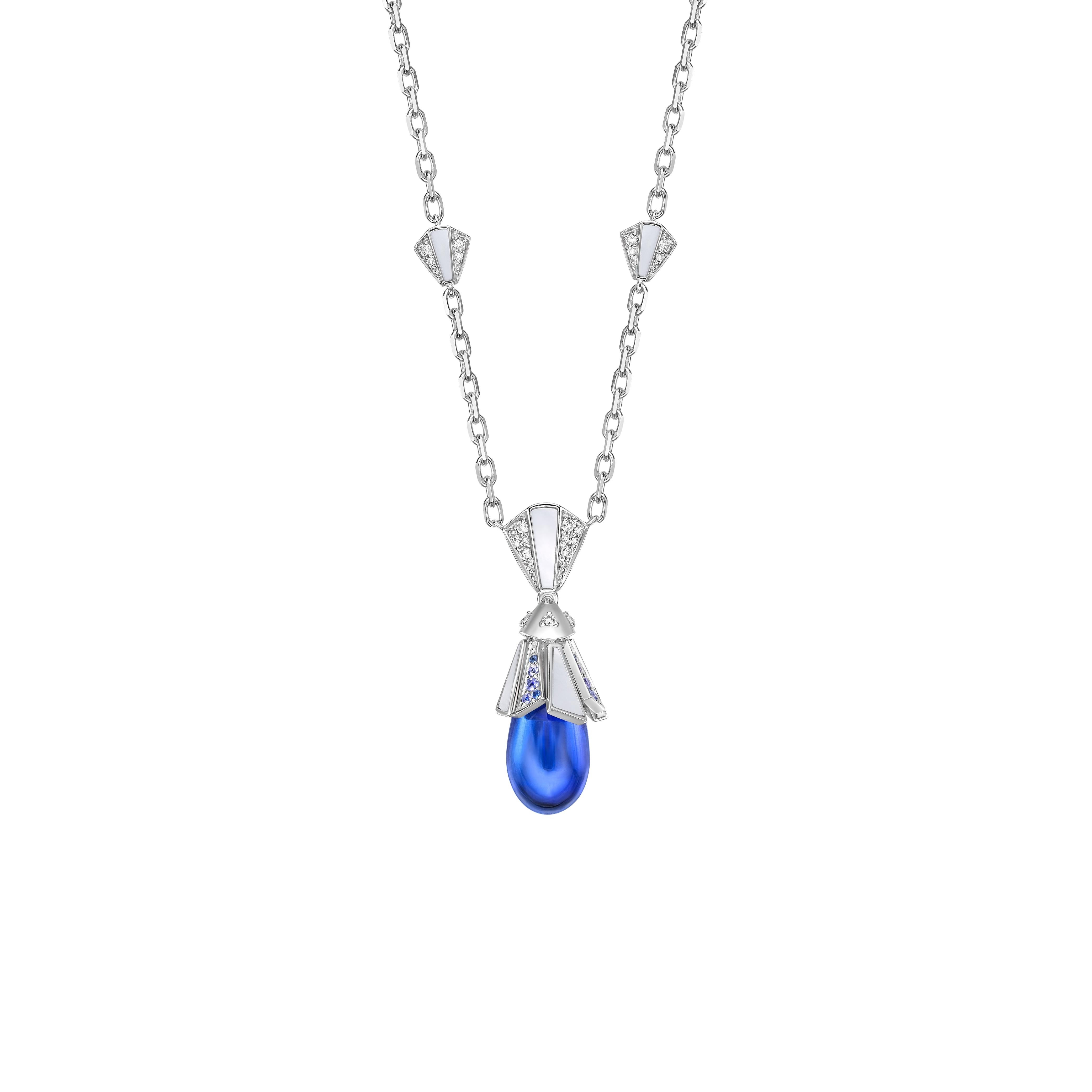 The pendant features a water drop-shaped Tanzanite stone with Tanzanite hue, adorned with mother of pearls. It's made of white gold and studded with diamonds and blue sapphire, making it suitable for any function or special moment.

Tanzanite