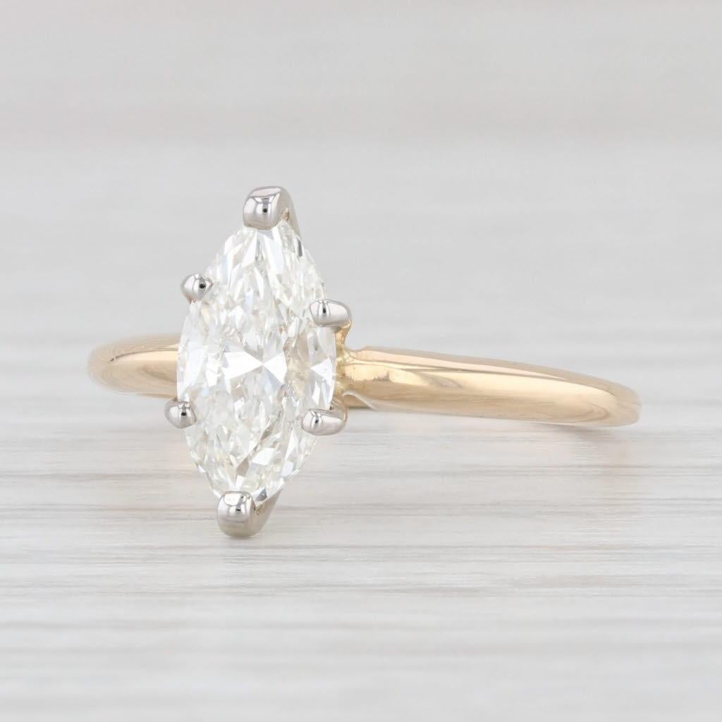 Gem: Natural Diamond - 1.10 Carats, Marquise Brilliant Cut, I Color, SI1 Clarity
Metal: 14k Yellow Gold
Weight: 2.3 Grams 
Stamps: 14k
Face Height: 11.2 mm 
Rise Above Finger: 7.01 mm

This ring is a size 4 3/4, but it can be resized down 1 size for