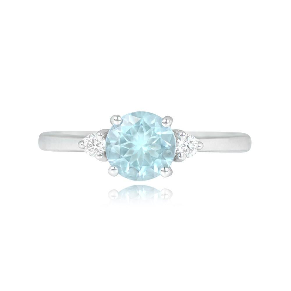 A gemstone engagement ring showcasing a 1.10-carat round-cut aquamarine, elegantly set in prongs and accompanied by two round brilliant-cut diamonds on the shoulders. The ring is beautifully crafted in 18k white gold.


Ring Size: 6.75 US,