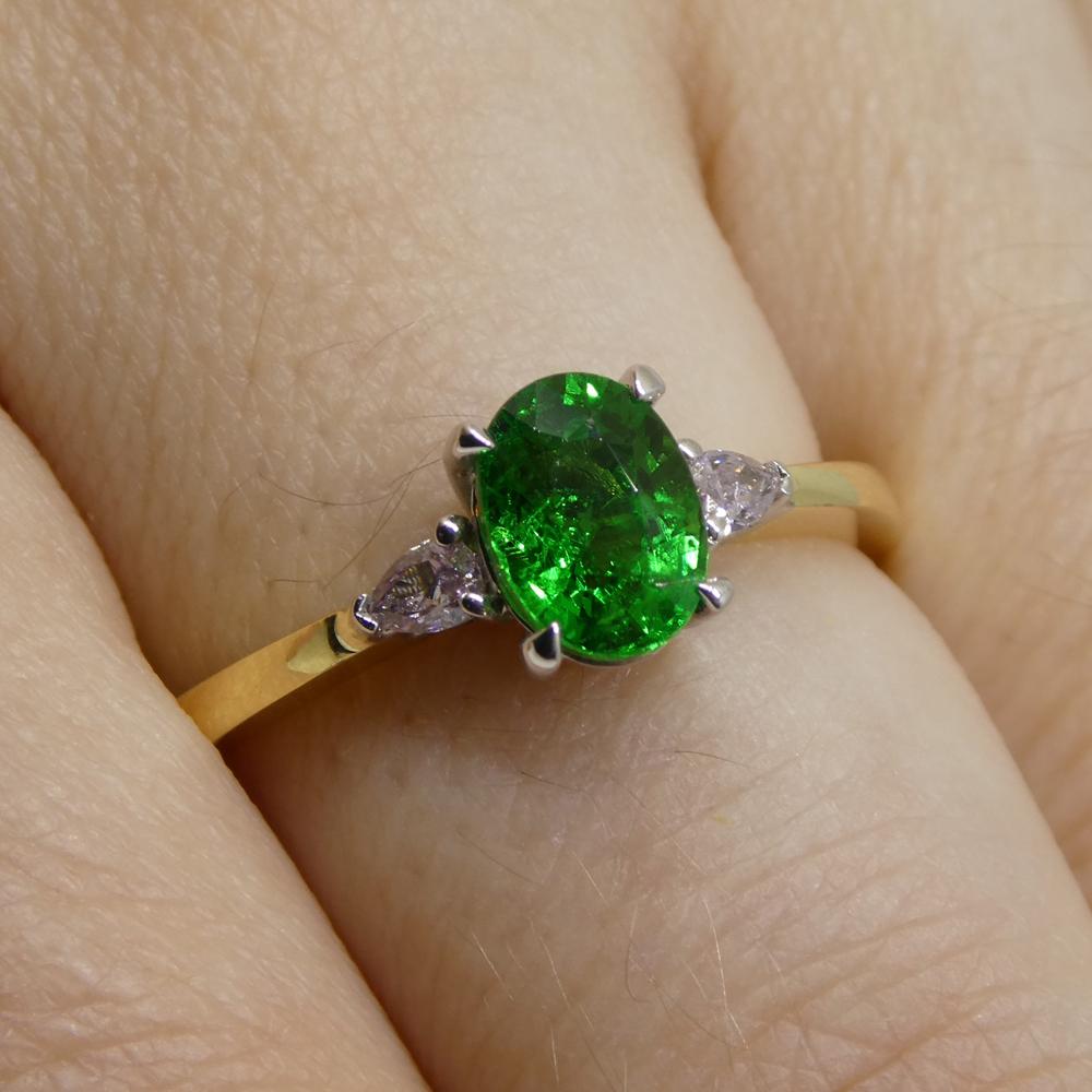 This is a stunning Tsavorite Garnet Ring, set with pink pear shape diamonds in an 18k yellow and white gold setting. 

This ring is made in Toronto, Canada, and is incredibly fine quality!

***

Gem Type: Garnet
Number of Stones: 1
Weight: 1.10