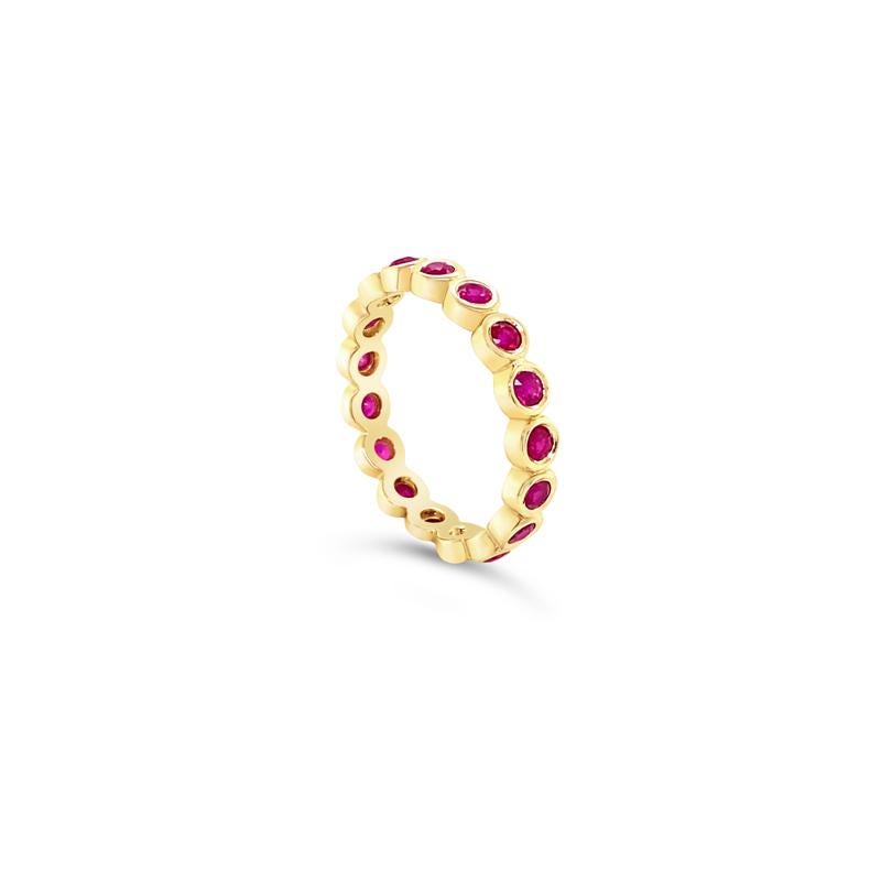 This beautiful eternity band features 1.10 carat total weight in round rubies set in 14 karat yellow gold bezel. This ring is a 6.75 and can be resized upon request. 
Measurements: approximately 3.75mm wide