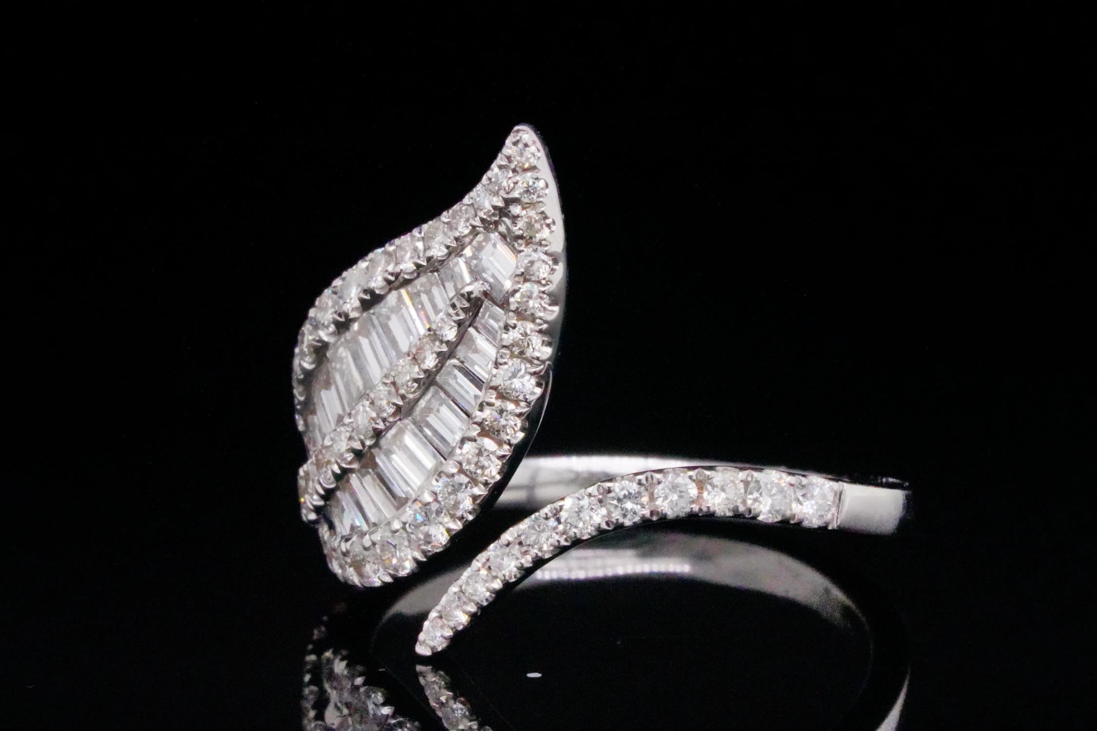 Very pretty and sparkling naturalistic leaf form ring. 1.10ctw VS1-VS2/G-H Diamond and 18K White Gold Leaf Ring - This lovely ring was finely crafted of solid 18k white gold and has an elegant design in the form of a leaf on a vine that wraps around