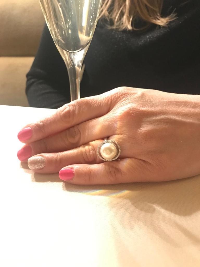 This simple but elegant freshwater pearl ring has classic appeal but with a contemporary twist. 

It features a double twisted row of 0.75 carat of the highest quality round brilliant cut cubic zirconia set delicately to allow the 11.0mm pearl to