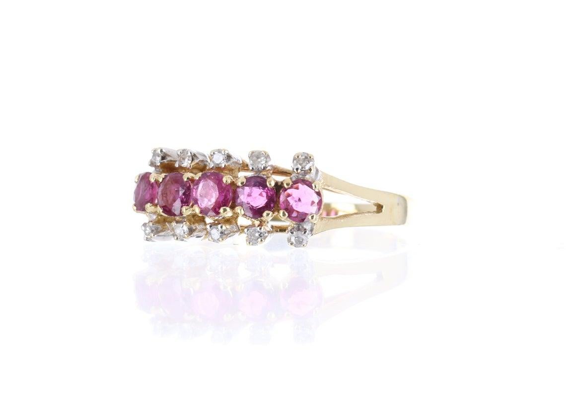 Elegantly displayed is a vintage ruby and diamond ring. Expertly handcrafted in gleaming 14K yellow gold; this ring features numerous natural rubies that lay horizontally across the finger. These beautiful rubies are a hot pink color and have