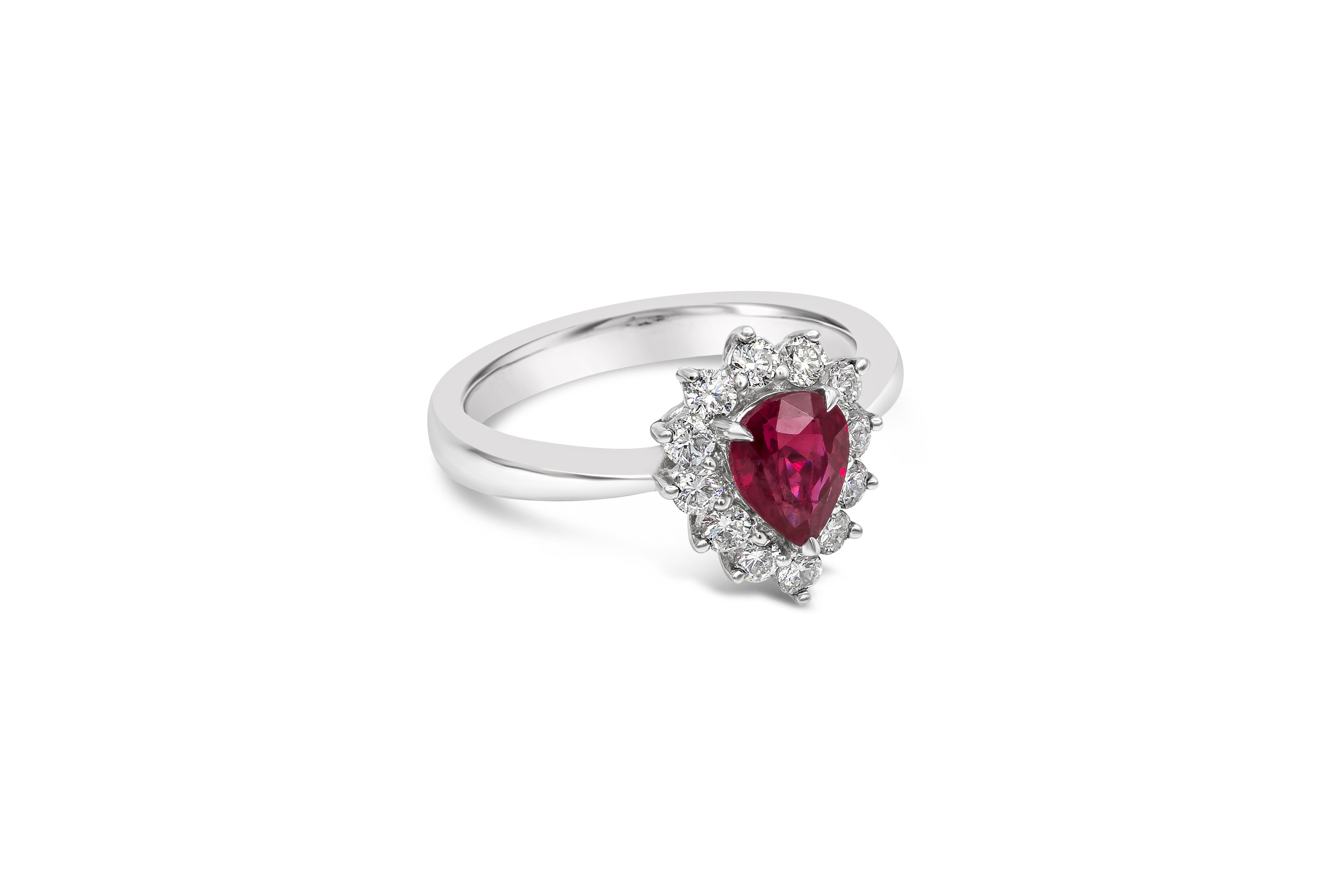 A beautiful and unique engagement ring style showcasing a 1.11 carats color-rich pear shape ruby. Surrounded by a single row of brilliant round diamond weighing 0.46 carats total. Finely made in 18k white gold. Size 6.5 US resizable upon