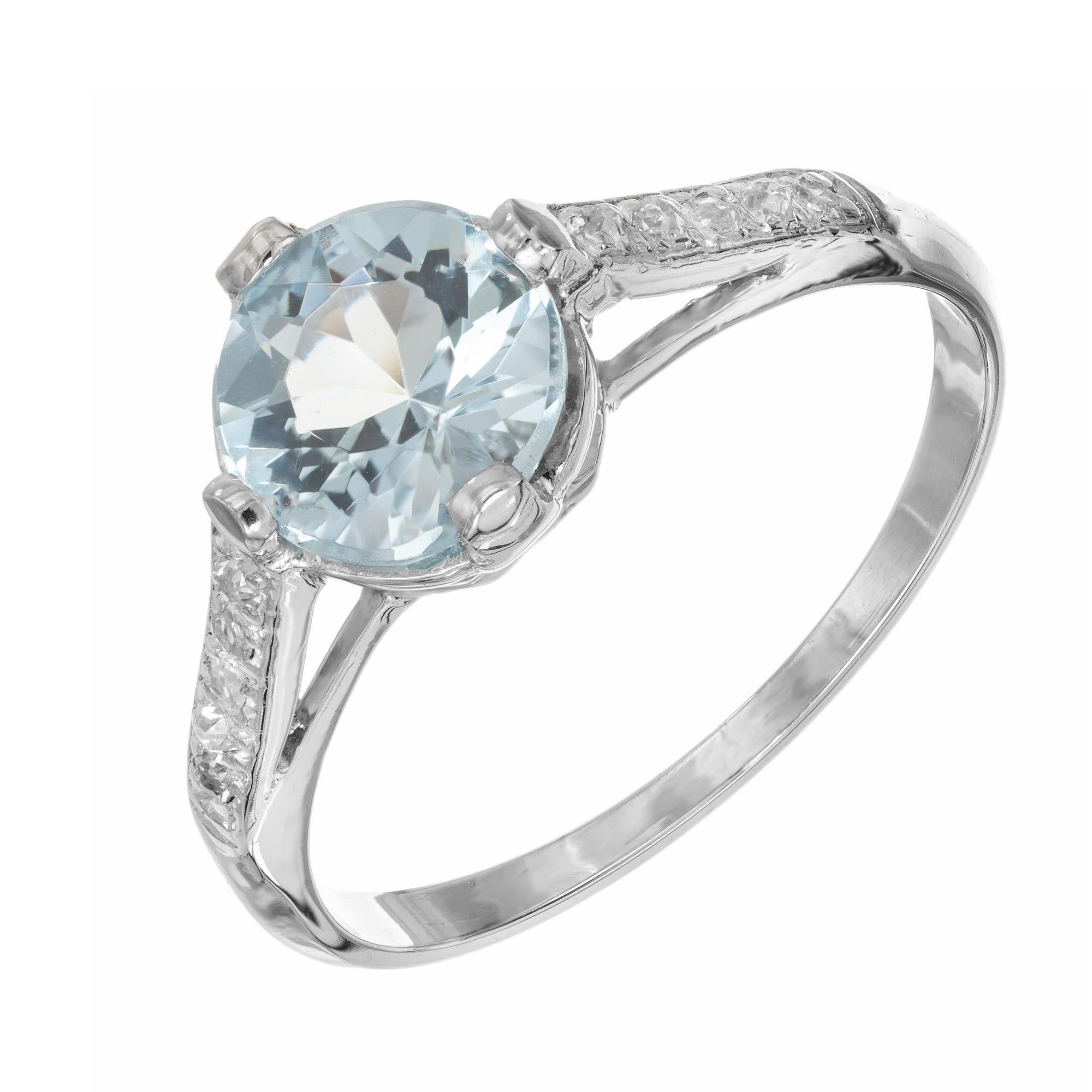 Aqua and diamond engagement ring. Beautiful bright round aquamarine center stone measuring 1.11cts. Mounted in a platinum four prong setting accented with 5 single cut diamonds along each shoulder.  This vintage ring dates back to the 1930's.

1