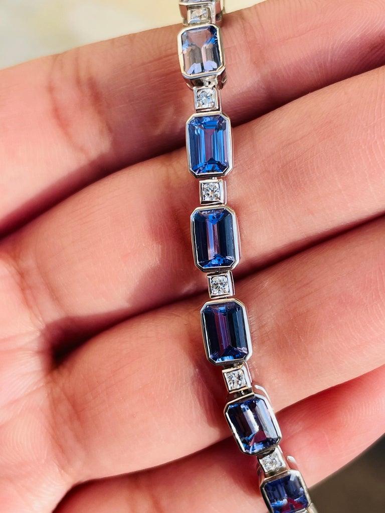 Captivating and luxurious, this stunning bracelet is crafted in radiant 18K white gold and showcases a series of beautifully cut emerald-shape tanzanite's, totaling 11.1 carats. The stones display an alluring spectrum of violet and periwinkle blue