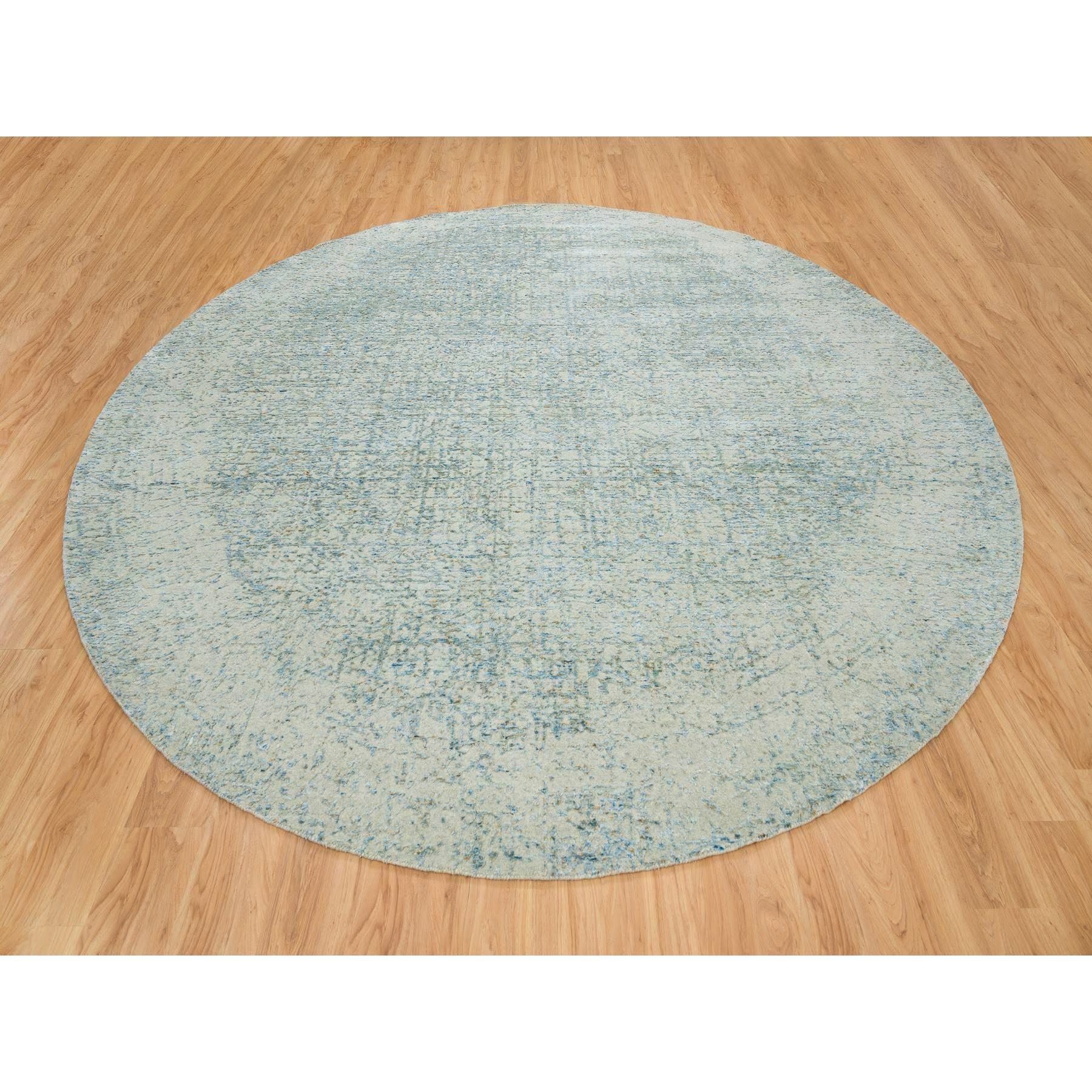 Gray with Touches of Blue, Wool and Plant Based Silk, Modern Jacquard Hand Loomed, Soft to the Touch, Round Oriental Rug 
Primary materials: Wool & Silk
Latex: No Pile 
height: 0.25 Inches
Style: Casual
Primary color: Grey
Secondary colors: Blue,