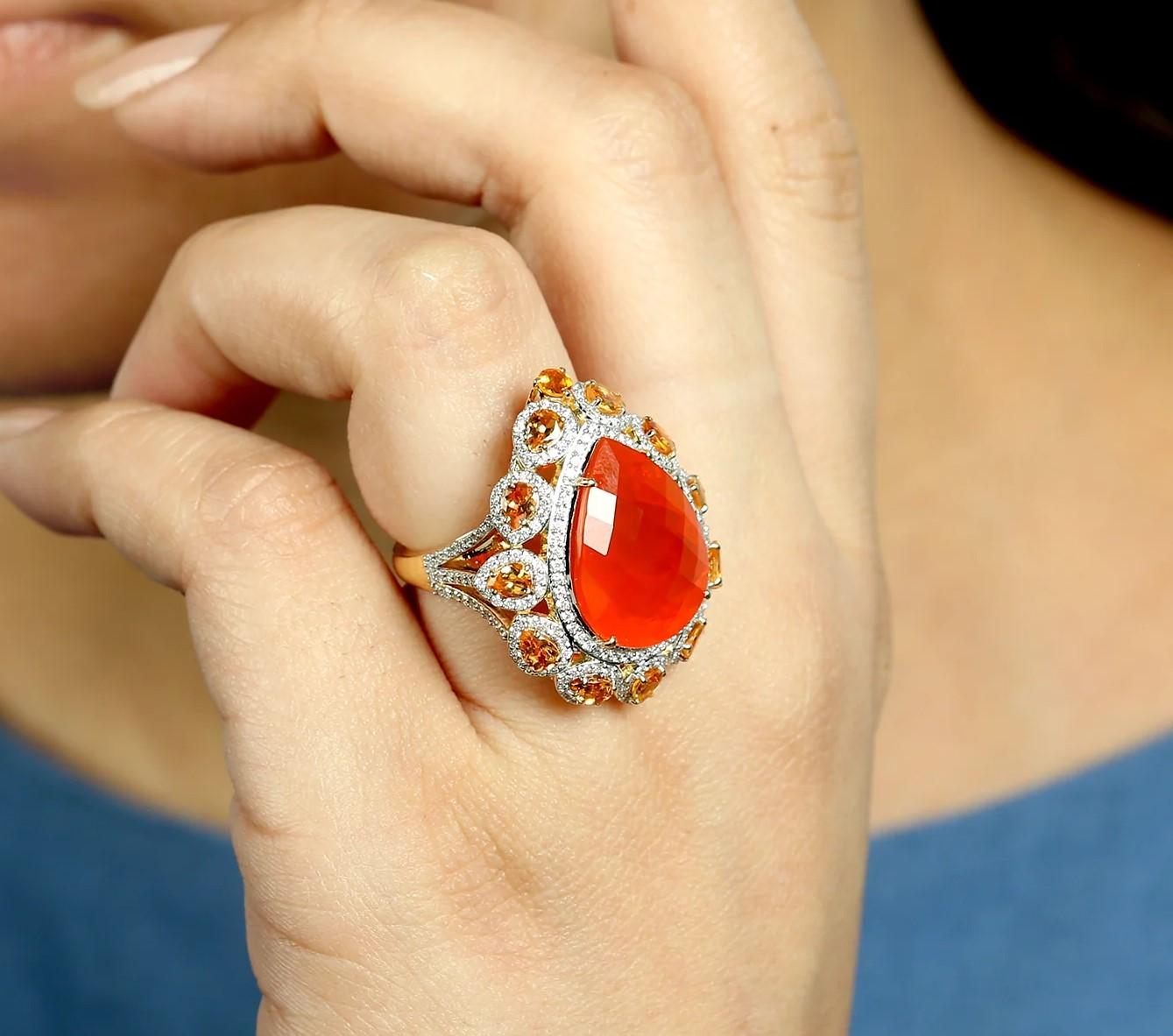 This exquisite ring is handcrafted in 18-karat gold. It is set in 11.16 carats fire opal, garnet and 1.38 carats of sparkling diamonds.

FOLLOW MEGHNA JEWELS storefront to view the latest collection & exclusive pieces. Meghna Jewels is proudly rated
